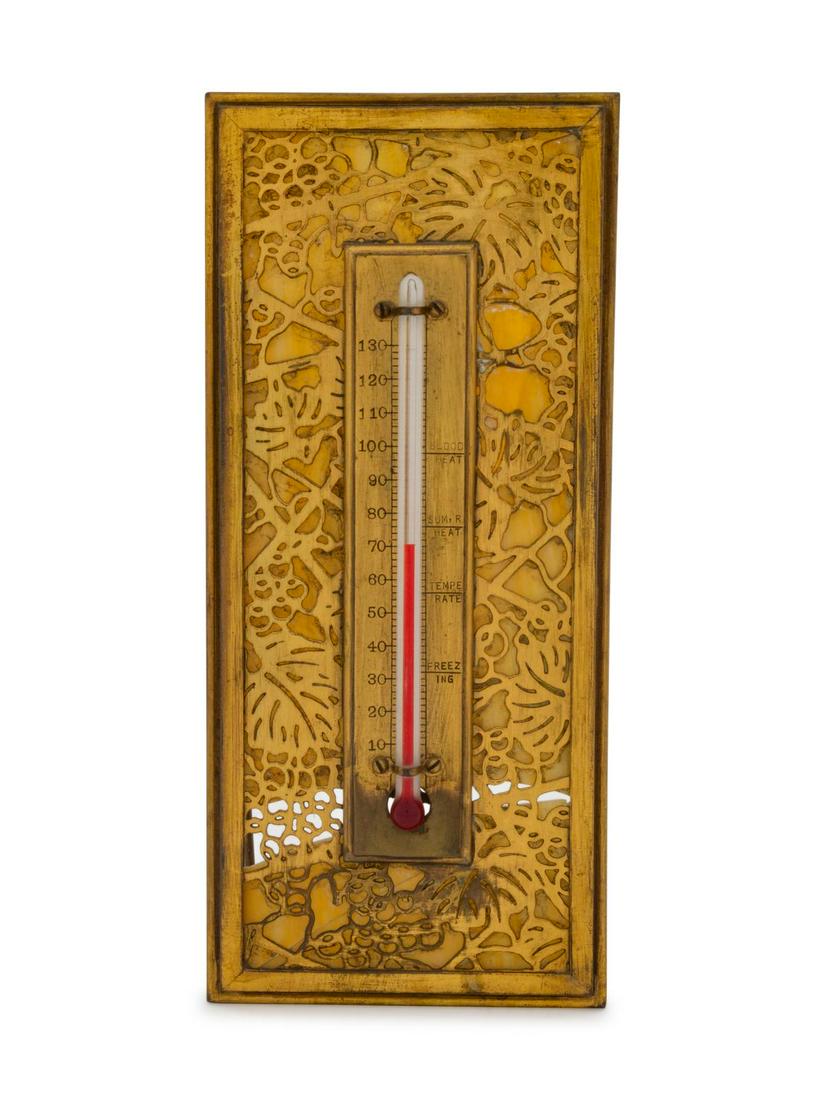 A Tiffany Studios Gilt Bronze and Glass Desk: A Tiffany Studios Gilt Bronze and Glass Desk Thermometer Grape Leaf pattern, stamped Tiffany Studios New York 1013 to the reverse. Height 8 5/8 x width 3 3/4 inches.