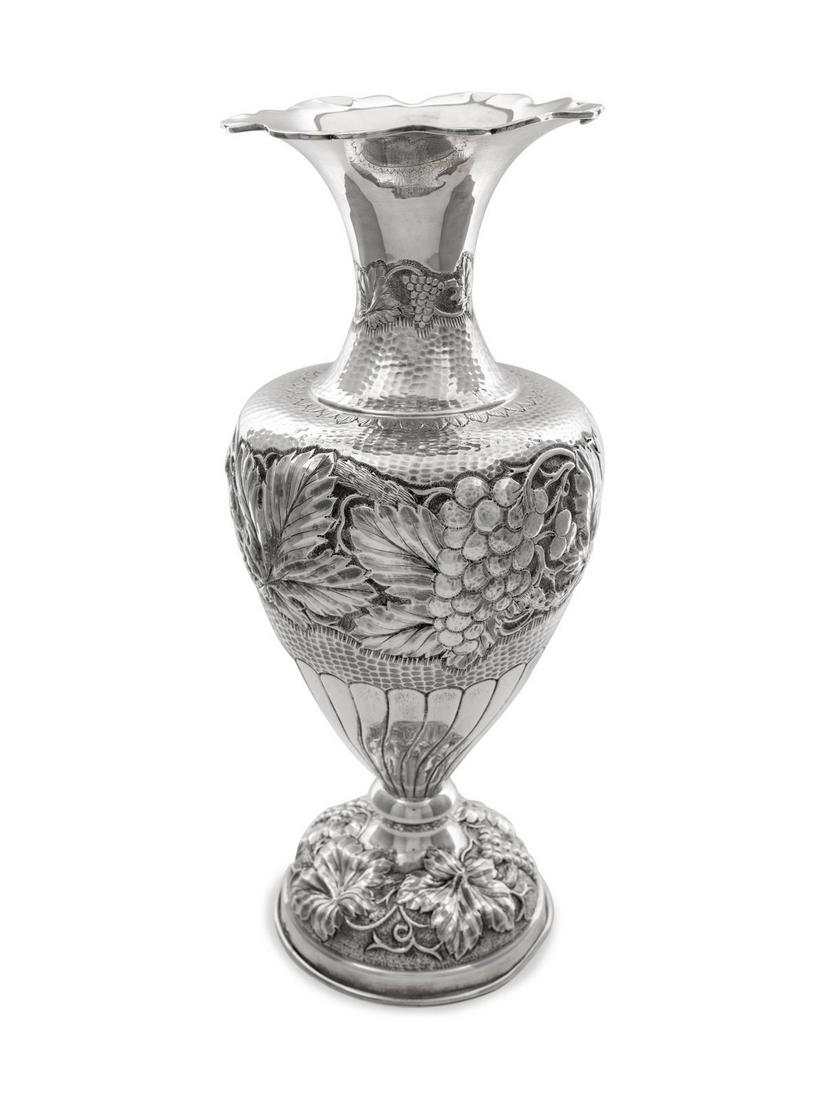 A Mexican Silver Vase: A Mexican Silver Vase of baluster form, decorated with fruit and foliage, weighted. Height 19 inches.