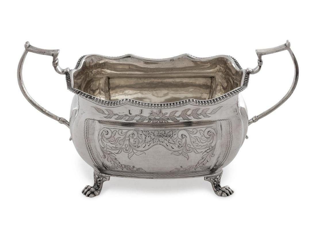 An Irish George III Silver Sugar Bowl: An Irish George III Silver Sugar Bowl John Moore, Dublin, 1817 having a gilt decorated interior and twin C-scroll handles, the body with an undulating gadroon rim and raised on four paw feet. hallmark