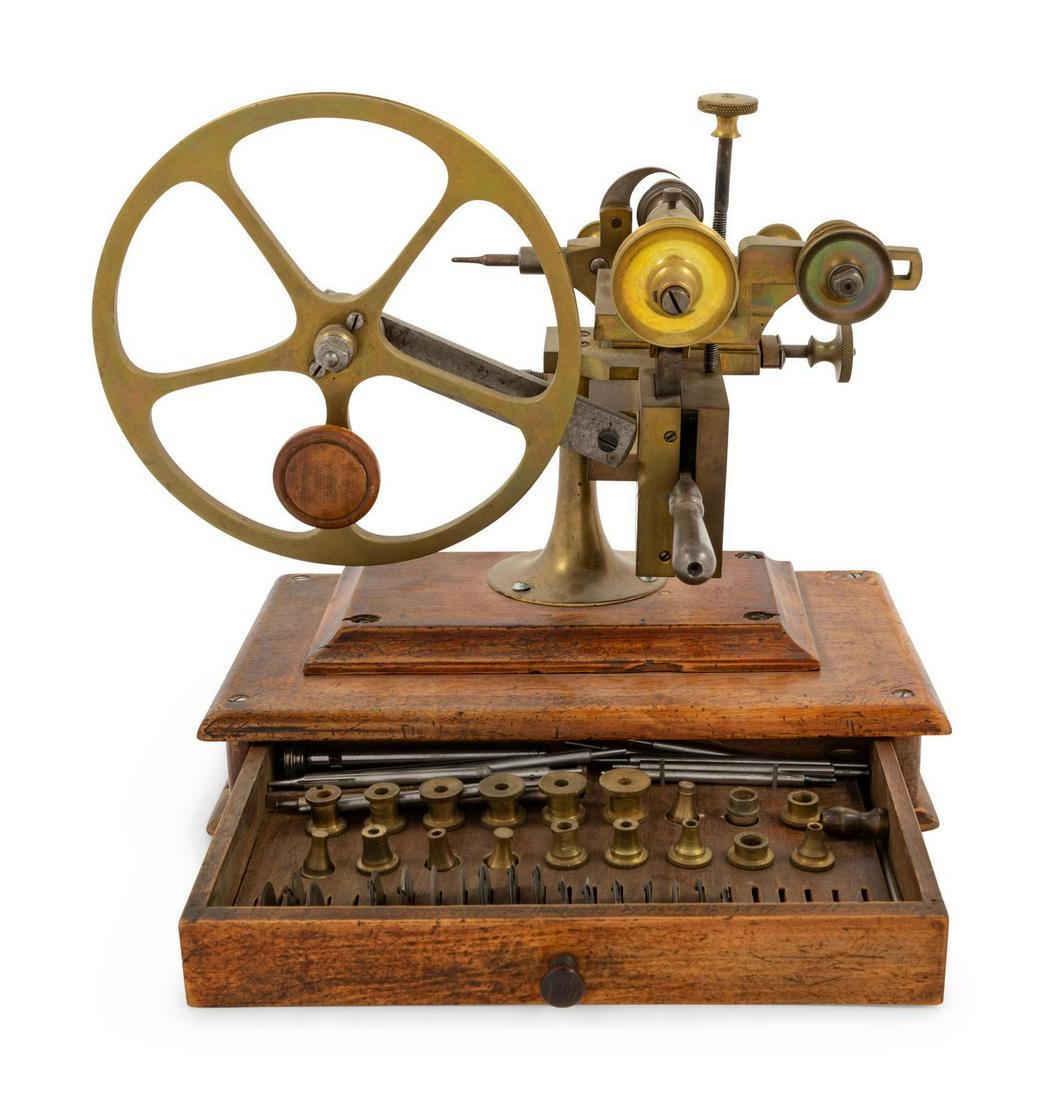 A Brass and Steel Watch Maker: A Brass and Steel Watch Maker's Rounding Up Tool 19th Century mounted to a wood base, the base drawer with extra bits and cutting wheels. Height 10 x width 11 inches overall. Property from a Midwest C