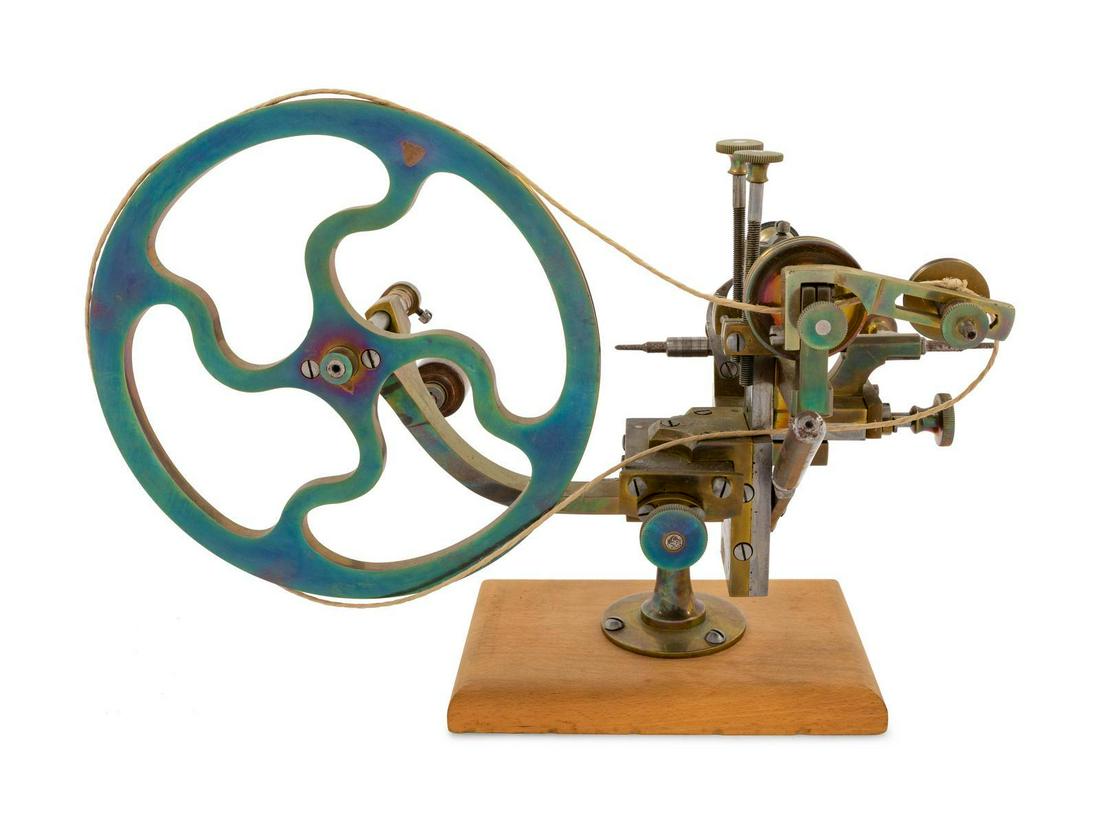 A Brass Watch Maker: A Brass Watch Maker's Rounding Up Tool mounted to a wood base.Â Height 9 5/8 inches overall. Property from a Midwest Collector