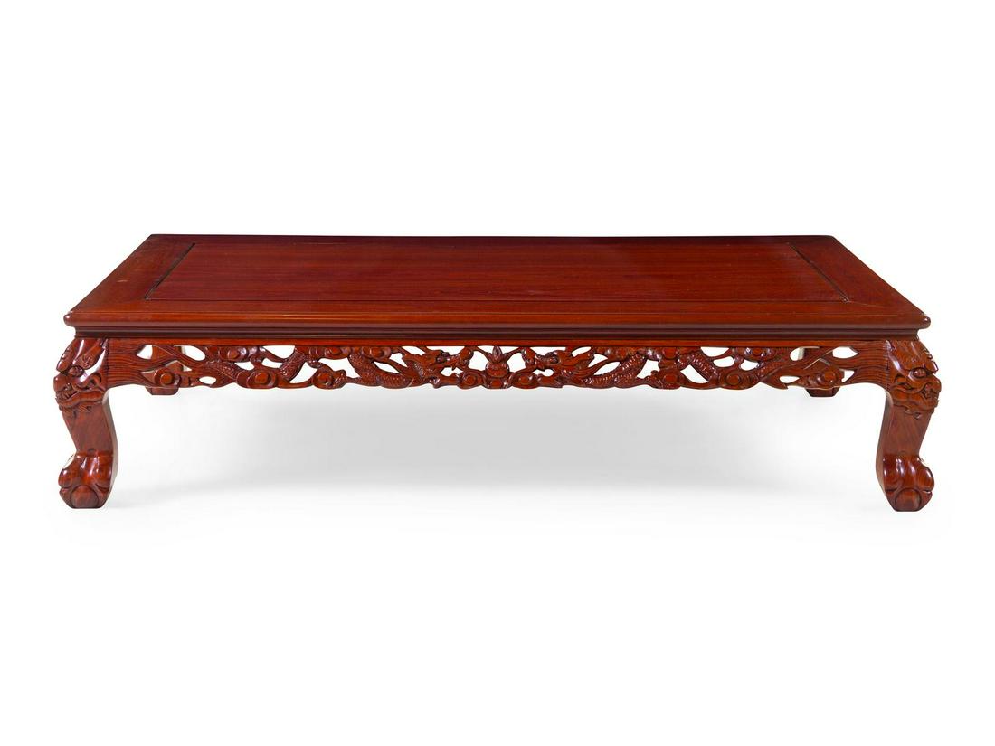 A Chinese Rosewood Occasional Table: A Chinese Rosewood Occasional Table 20th Century having a rectangular top above a foliate apron, raised on scrolled legs.Â Height 14 1/4 x width 60 x depth 37 inches. Property from the Collection o