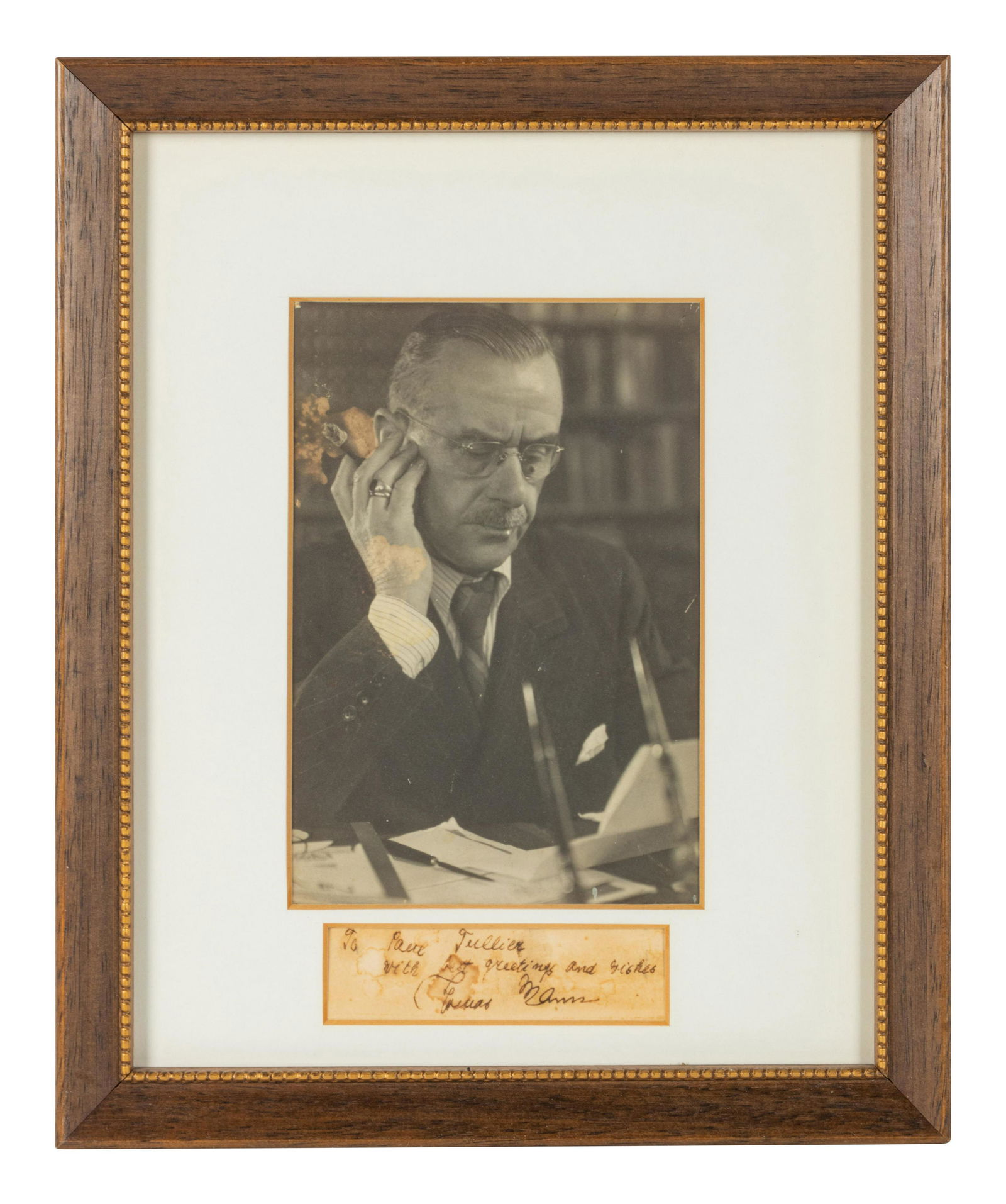MANN, Thomas (1875-1955). Autograph note signed, "To: MANN, Thomas (1875-1955). Autograph note signed, "To Paul Tullier with best greetings and wishes, Thomas Mann," n.d. 25 x 90 mm (visible area), matted and framed with black and white photographic port
