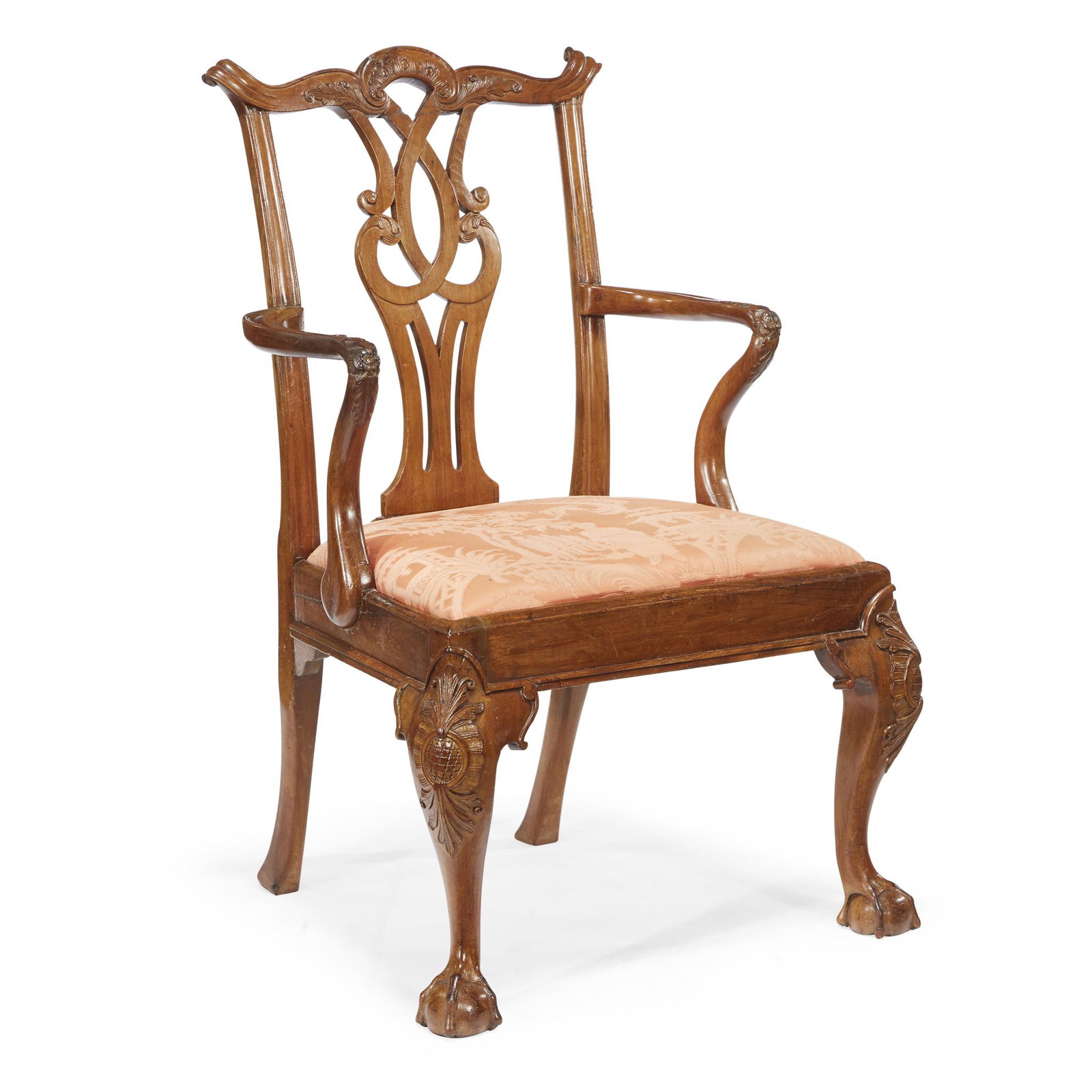 A George III carved walnut armchair, circa 1765: A George III carved walnut armchair circa 1765 With shaped and carved scrolled crestrail and pierced splat over shaped foliate-carved armrests, with square seatrail raised on cabriole legs with cartou
