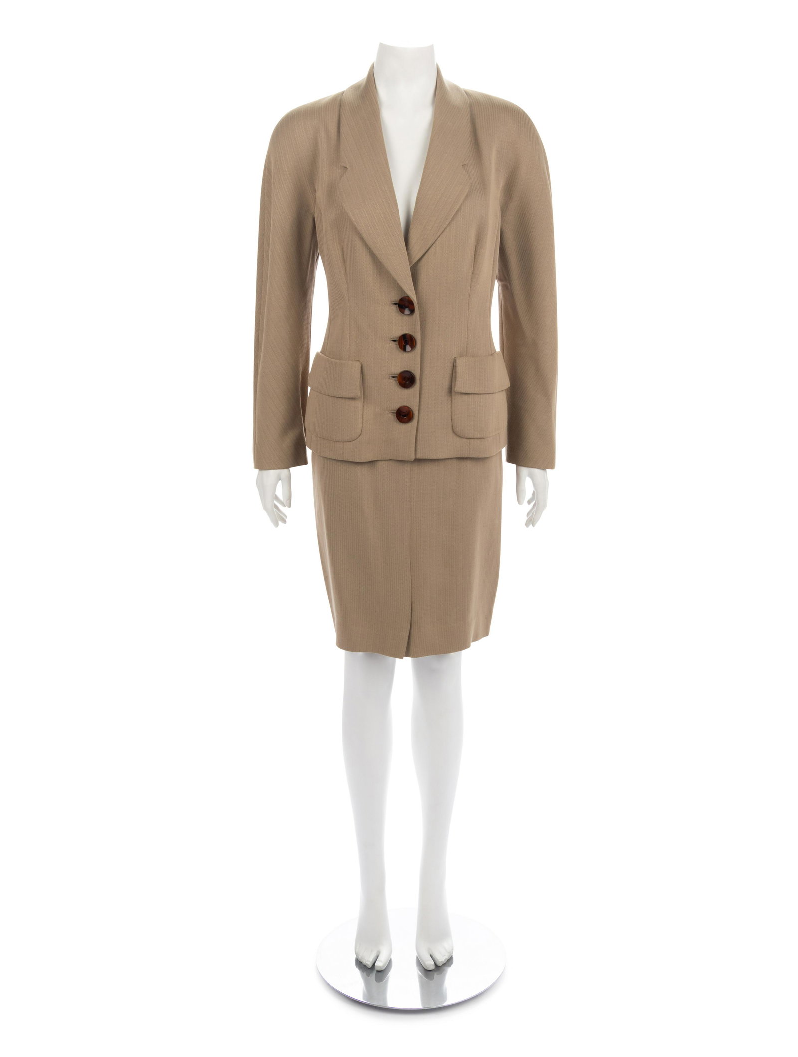 Two Gianfranco Ferre Skirt Suits, 1980-90s: Two Gianfranco Ferre Skirt Suits, 1980-90s This lot includes two skirt suit ensembles. THE FIRST Tan rayon/polyester blend chevron pattern jacket with notch shaped shawl collar, front hip patch pock