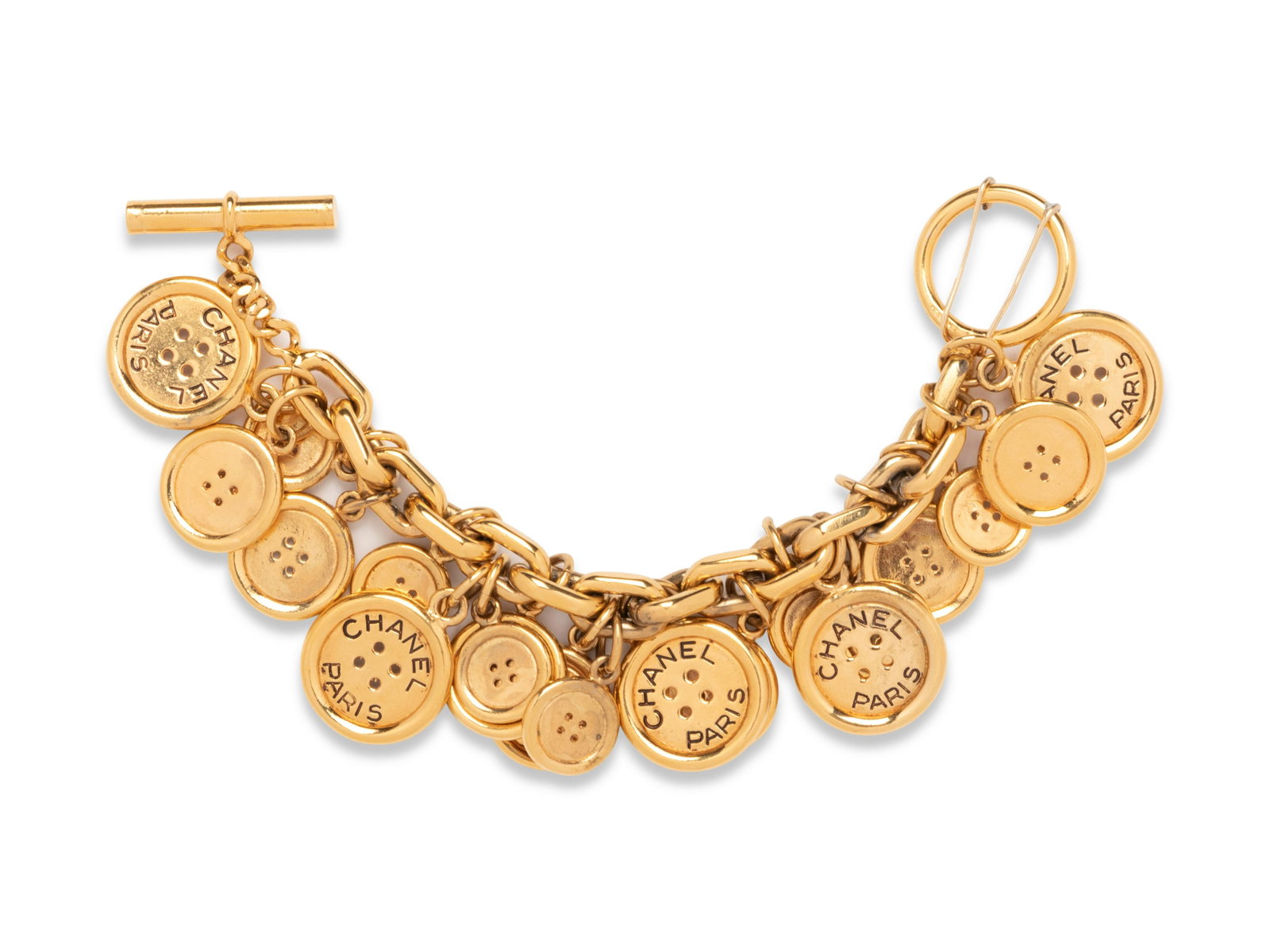 Chanel Charm Button Bracelet, Early 1970s: Chanel Charm Button Bracelet, Early 1970s Gold-tone chain bracelet with goldtone button charms in three sizes. The largest buttons are stamped with "Chanel / Paris". Comes with Chanel box.Â Stamped