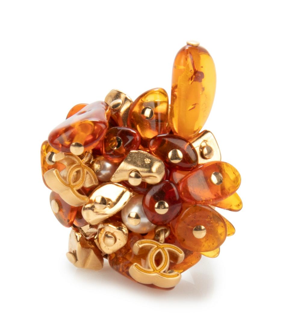 Chanel Cluster Ring, 2011: Chanel Cluster Ring, 2011 Gold-tone cluster ring with amber-like, gold-tone, pearl, and CC logo beads. This ring goes with a matching necklace and pair of earrings also available in this auction. La