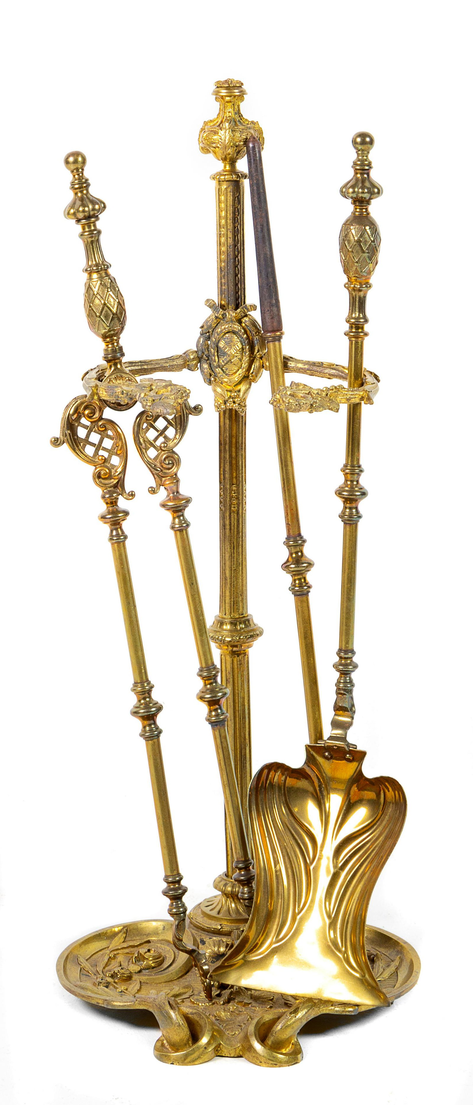 A Set of French Gilt Bronze Fireplace Tools Height of: A Set of French Gilt Bronze Fireplace Tools LATE 19TH CENTURY comprising a shovel, poker, tongs and a stand. Height of stand 29 5/8 inches. Provenance: Property from an Important Private Collection