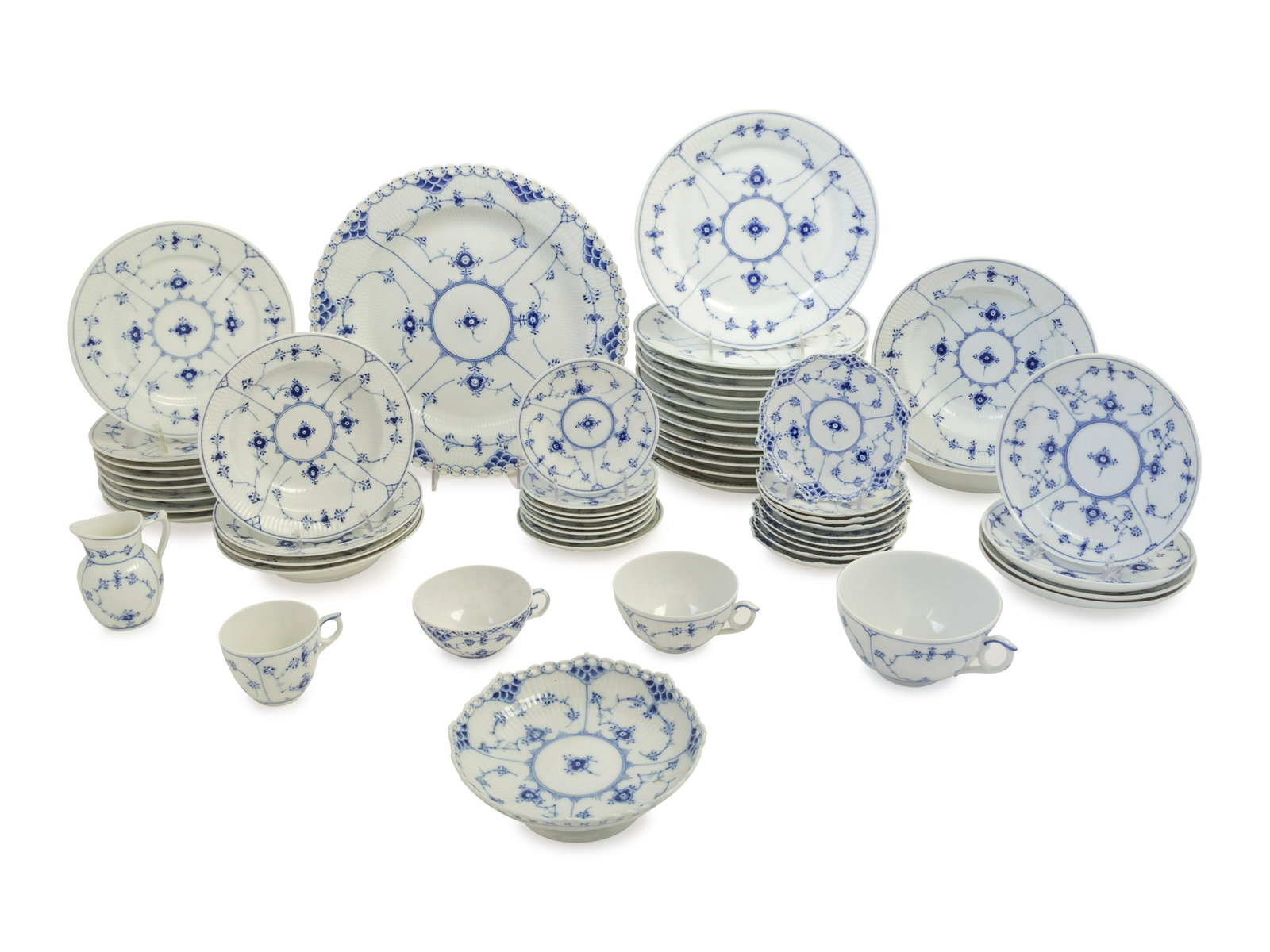A Royal Copenhagen Porcelain Dinner Service Diameter of: A Royal Copenhagen Porcelain Dinner Service comprising a circular platter, 5 salad plates, 5 oversize cups with 3 saucers, 17 saucers in two sizes, 4 soup bowls in two sizes, 16 teacups in various siz