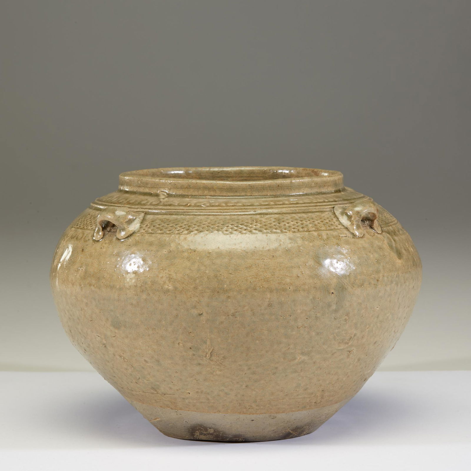 A Chinese celadon-glazed stoneware small jar, Eastern (1 of 2)
