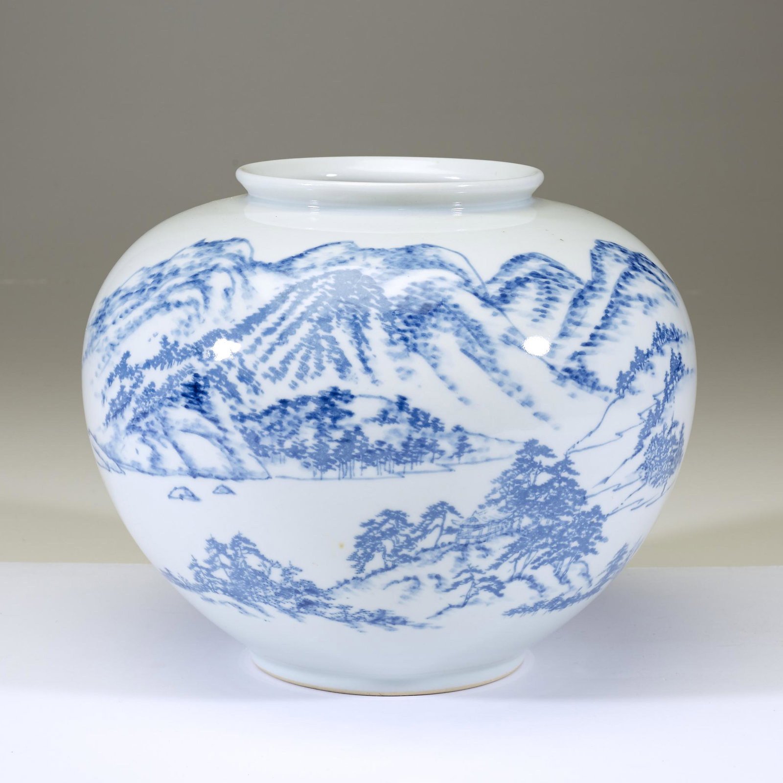 A Korean blue and white porcelain presentation vase,: A Korean blue and white porcelain presentation vase. 20th century. Decorated with a river and mountain landscape, underside inscribed "Presented by Mayor of Inchon City" and "Incheon jighalsijang" in 