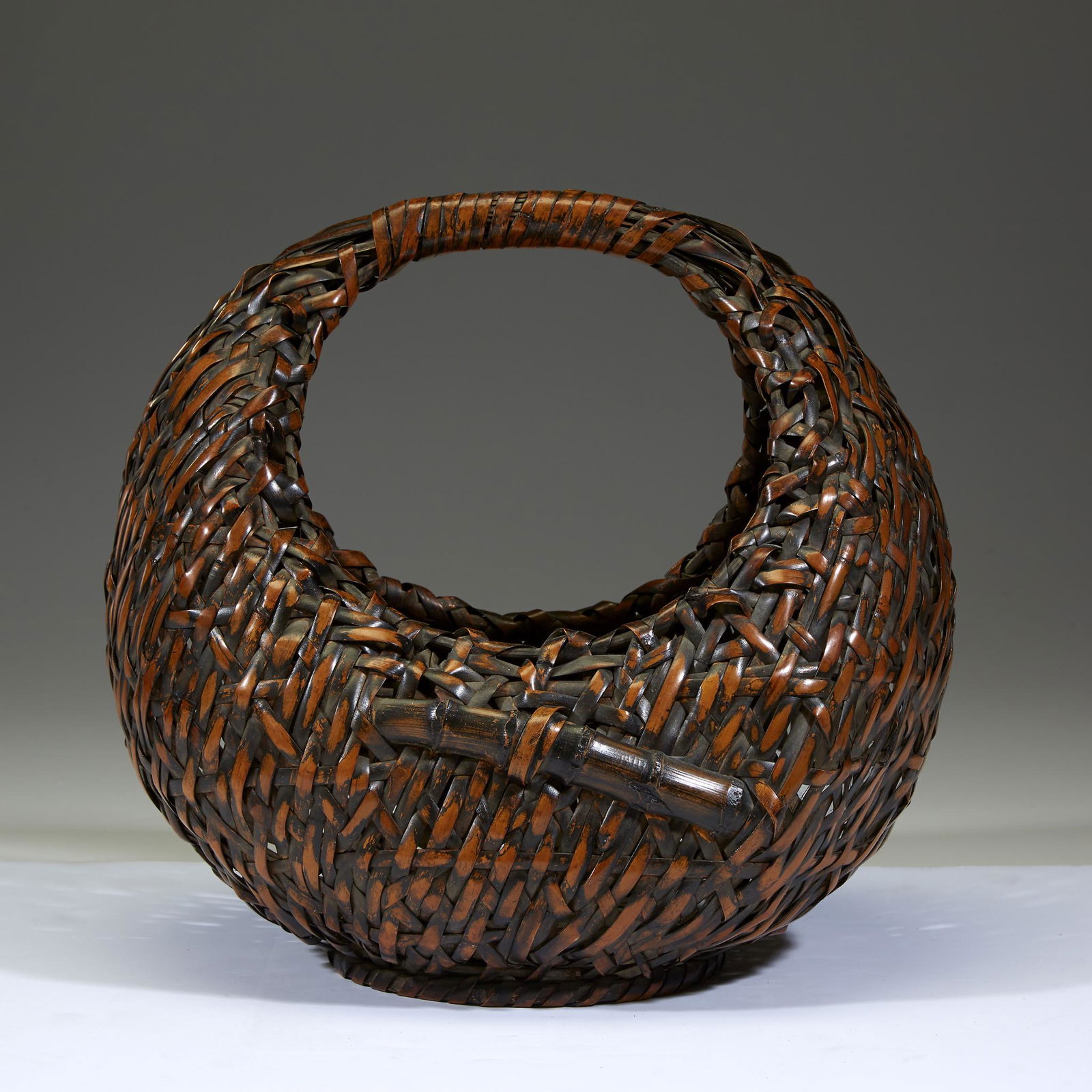 A Japanese woven bamboo â€œMoonâ€ basket, signed (1 of 2)