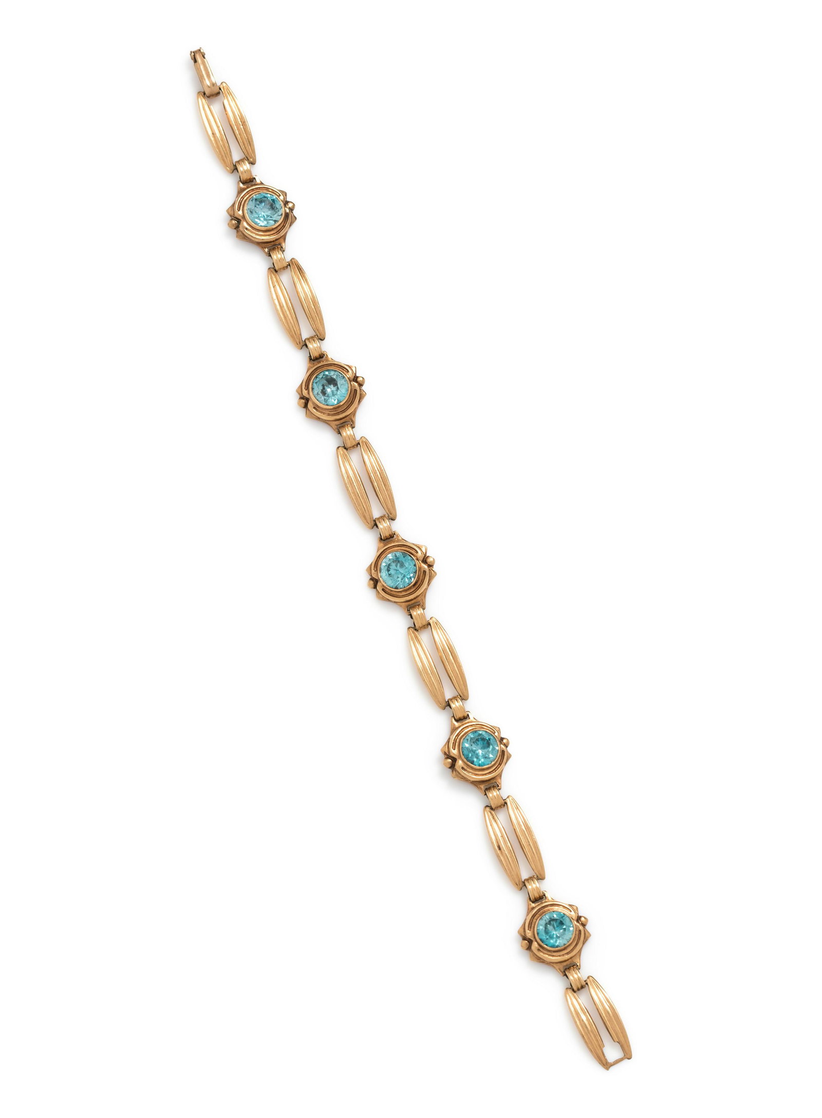 YELLOW GOLD AND BLUE ZIRCON BRACELET: YELLOW GOLD AND BLUE ZIRCON BRACELET Containing five round mixed cut blue zircons measuring approximately 6.00 mm in diameter. Stamp: 14K (maker's mark). 6.60 dwt.