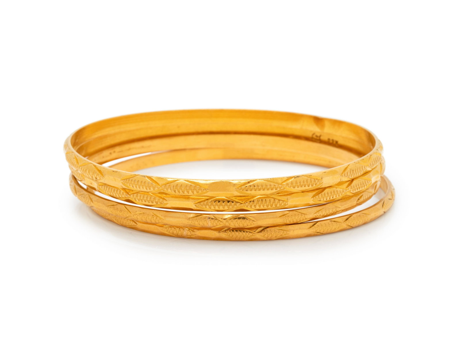 HIGH KARAT GOLD BANGLE SET: HIGH KARAT GOLD BANGLE SET Consisting of four bangles measuring approximately 2.80-3.50 mm wide. Stamp: (maker's mark) 22K. 34.15 dwt. Property from an Important Collection, Atlanta, Georgia