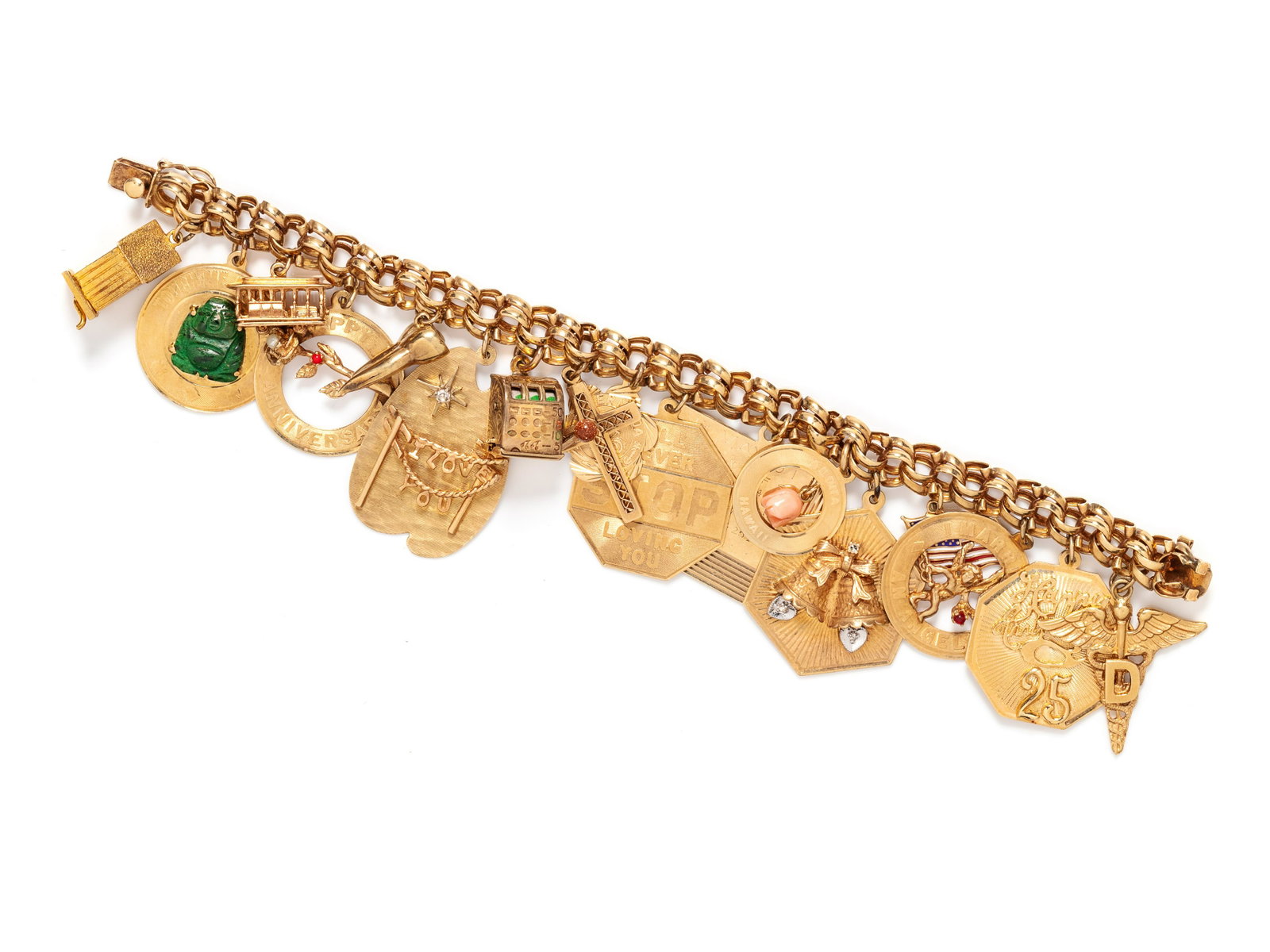 YELLOW GOLD CHARM BRACELET: YELLOW GOLD CHARM BRACELET Consisting of a double rolo chain bracelet suspending a rotating Beefeater charm, a disc charm surmounted with a carved hardstone Buddha, a San Francisco streetcar charm, a 