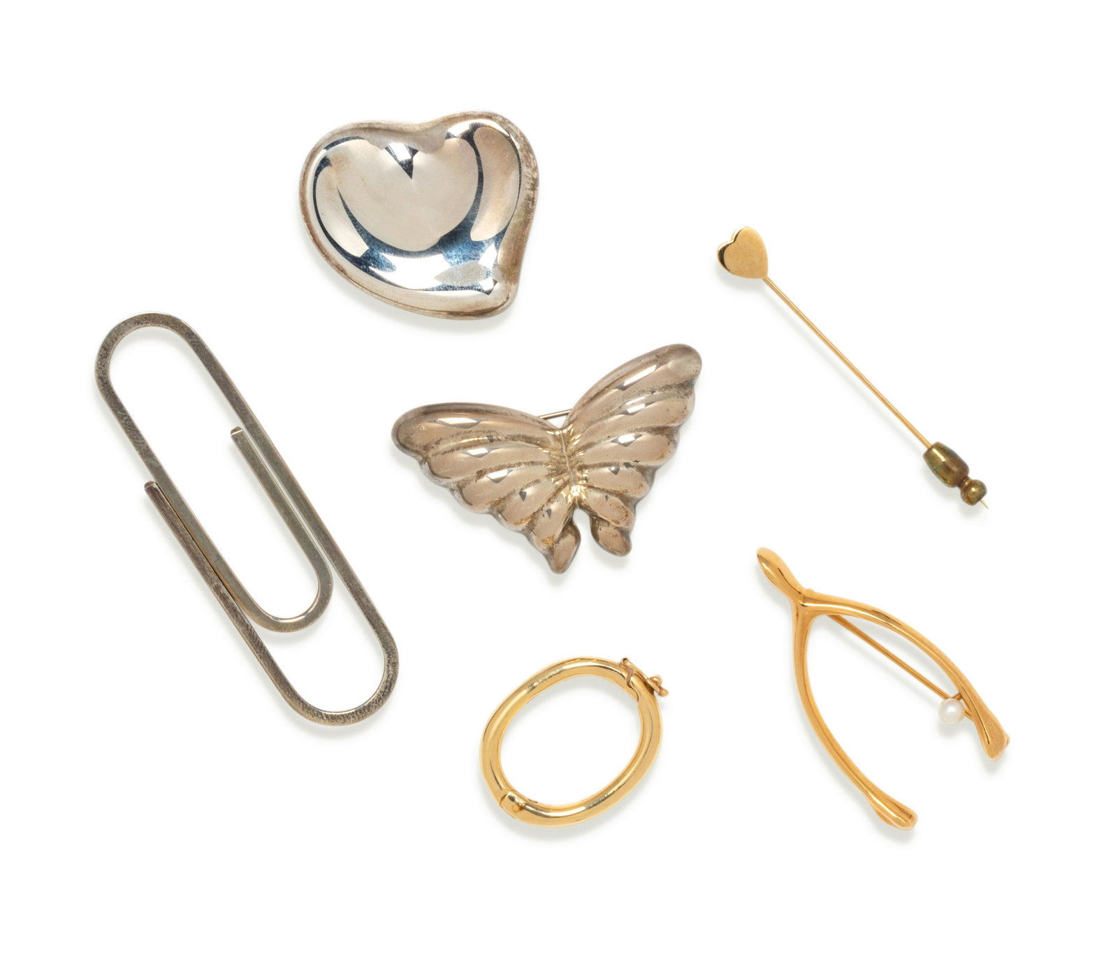 COLLECTION OF ACCESSORIES: COLLECTION OF ACCESSORIES Consisting of a sterling silver butterfly brooch by Tiffany & Co., a sterling silver heart by Elsa Peretti for Tiffany & Co., a yellow gold shortener clasp, a sterling silver