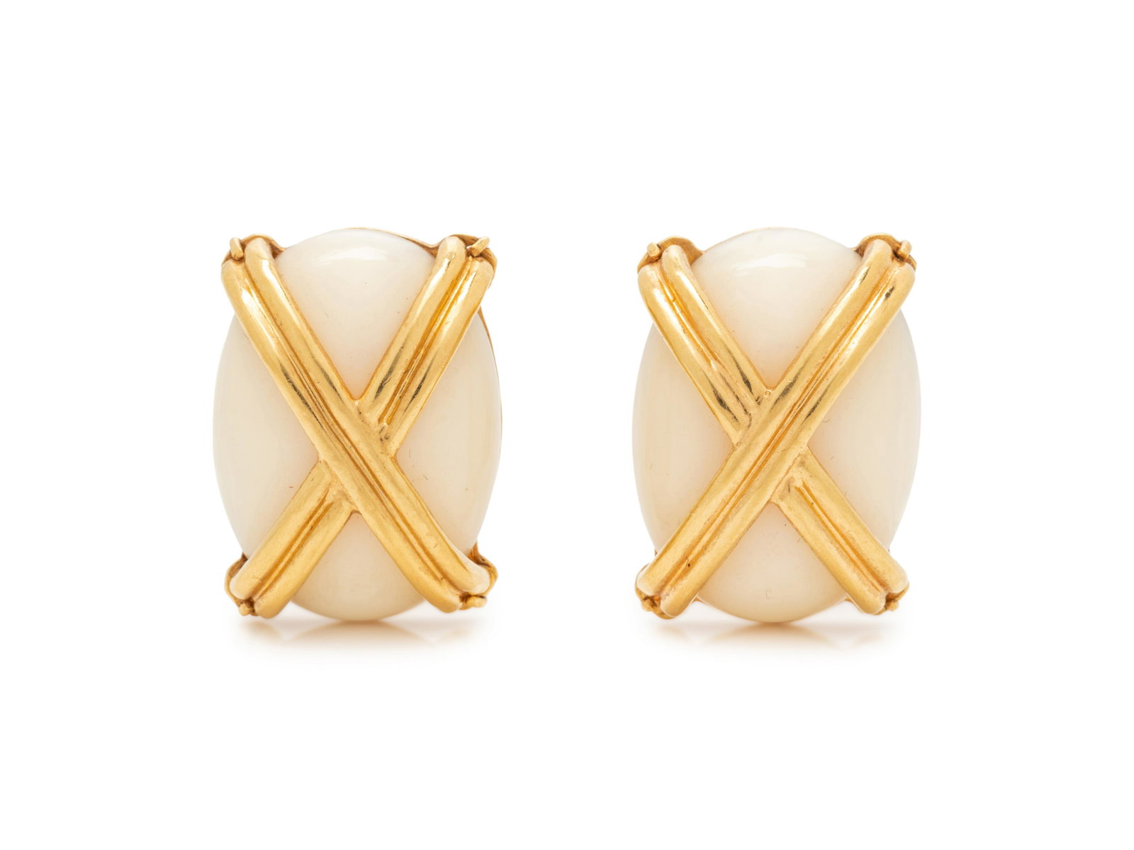 EMIS, YELLOW GOLD AND WHITE CORAL EARCLIPS: EMIS, YELLOW GOLD AND WHITE CORAL EARCLIPS Consisting of two oval shape white coral measuring approximately 26.00 x 18.70 mm, surmounted with yellow gold X motifs. Stamp: EMIS 18K. 19.30 dwt.