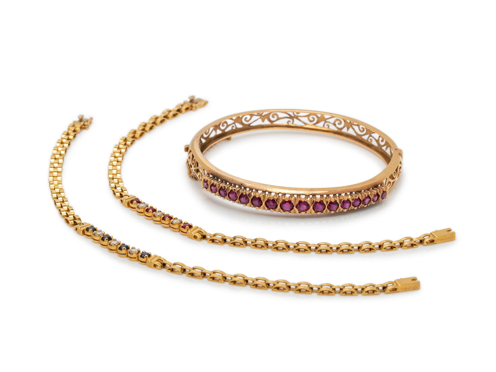 COLLECTION OF YELLOW GOLD AND GEMSTONE BRACELETS: COLLECTION OF YELLOW GOLD AND GEMSTONE BRACELETS Consisting of a bangle bracelet containing 16 round mixed cut rubies measuring approximately 2.50-3.50 mm in diameter, hinged with side clasp, a bracel