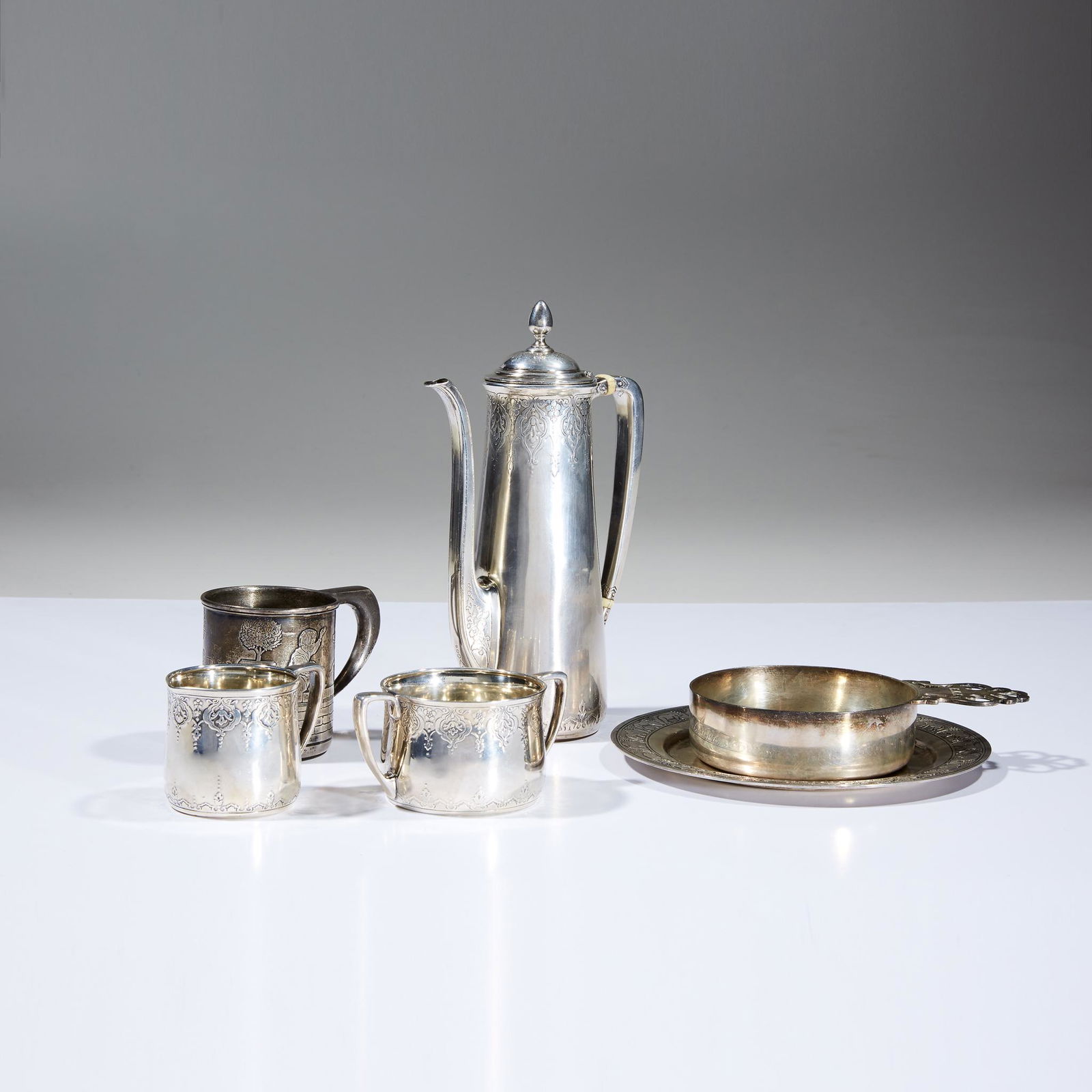An assembled group of sterling silver table wares,: An assembled group of sterling silver table wares. Tiffany & Co., New York, NY, various date marks from 1907-1965. Comprising a three-piece silver coffee service: coffeepot, creamer, and sugar dish; a