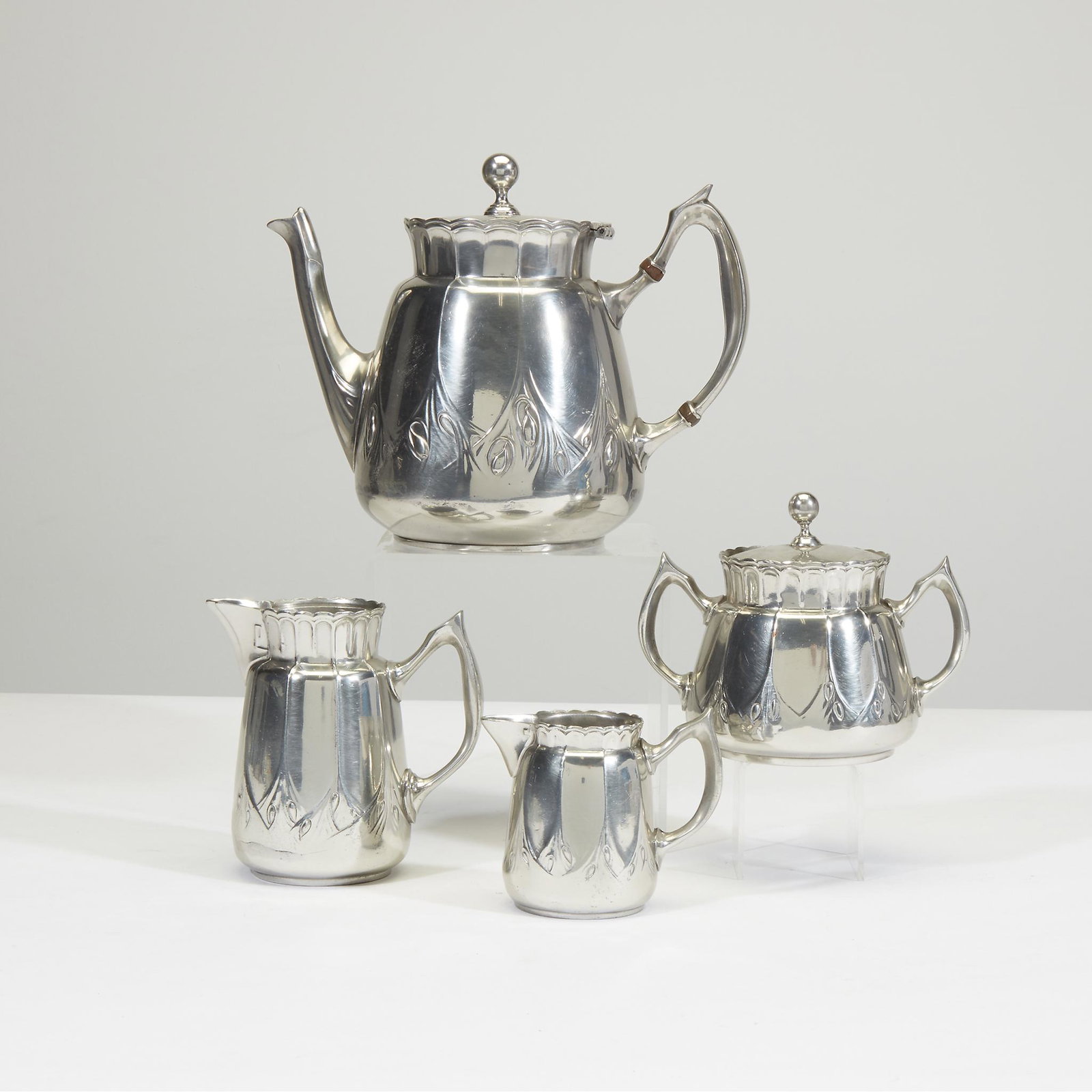 Kayserzinn (German, active 1862-1925), Four-piece: Kayserzinn (German, active 1862-1925) Four-piece pewter tea service, Germany, early 20th century. Comprising a teapot, a covered sugar bowl, and two creamers. H: 7 in., W: 8 1/4 in. (teapot) PROVENANC