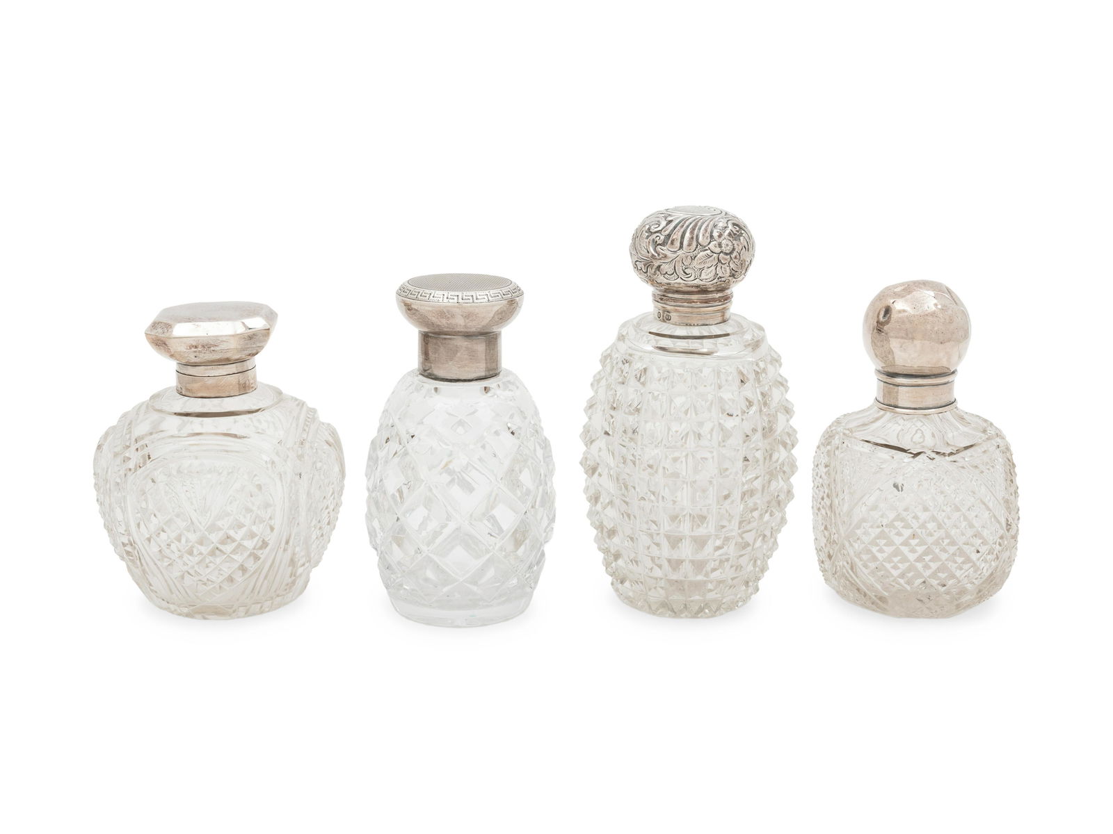 Four English Silver Mounted Cut Glass Bottles: Four English Silver Mounted Cut Glass Bottles Circa 1900 Height of tallest 6 inches. Property from the Collection of Mr. James Lee Soffer, Pittsburgh, Pennsylvania