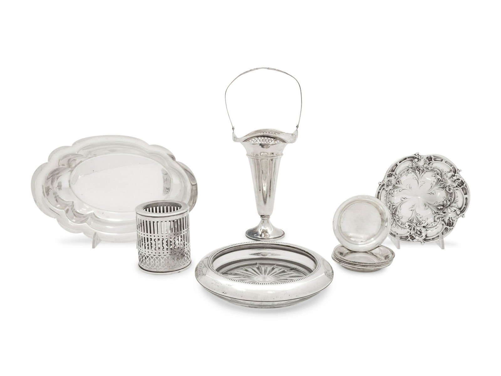 A Collection of Silver and Silver Filled Articles: A Collection of Silver and Silver Filled Articles 20th Century comprising six coasters, wine holder, trumpet vase, tray, dish, and cup. Length of tray 9 3/4 inches.