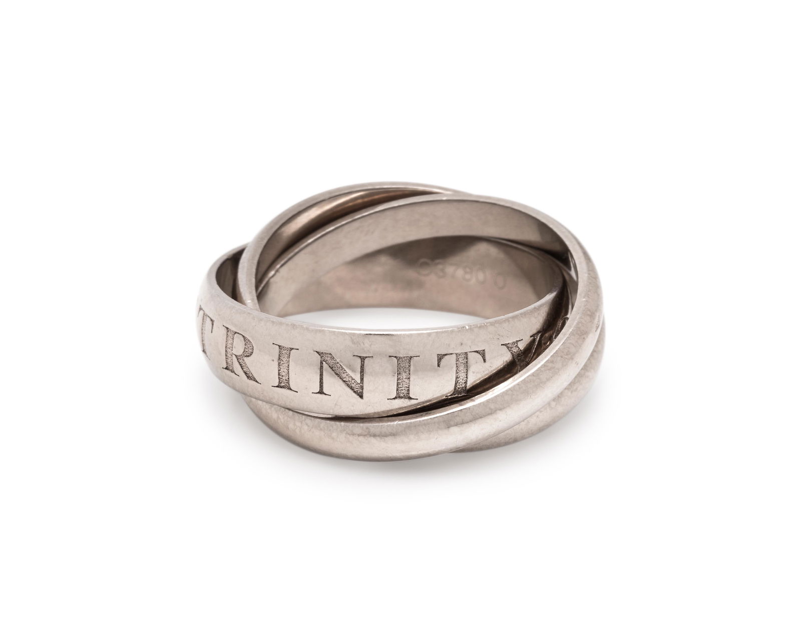 CARTIER, WHITE GOLD 'OR AMOUR ET TRINITY' RING: CARTIER, WHITE GOLD 'OR AMOUR ET TRINITY' RING Consisting of three interlocking rings, one with 'OR AMOUR ET TRINITY' engraved. Stamp: 750 Cartier 57 1998 O3780 O (French hallmarks). 7.90 dwt. Propert