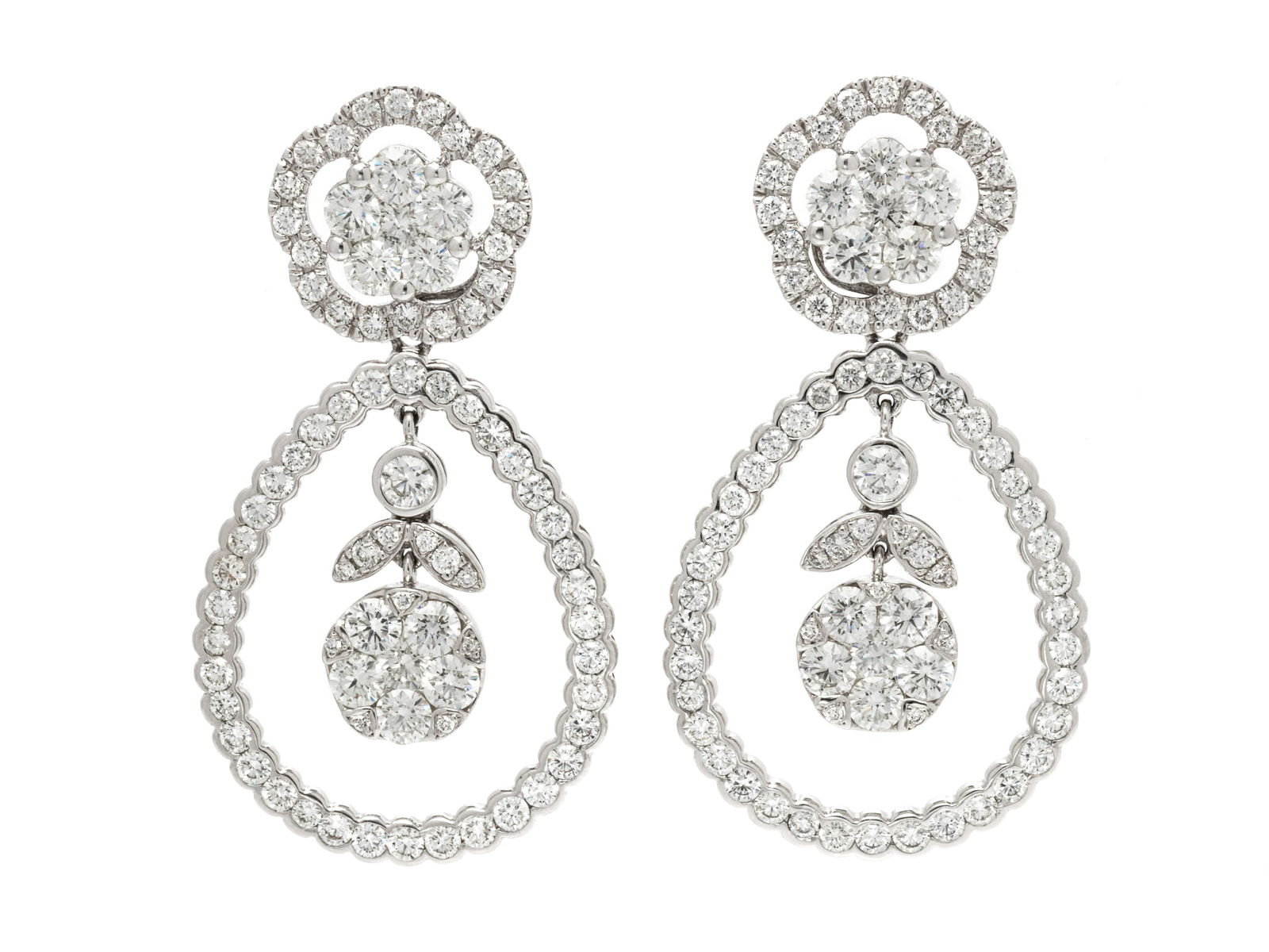 CONVERTIBLE DIAMOND EARRINGS: CONVERTIBLE DIAMOND EARRINGS Consisting of diamond cluster earrings with two removable flower motif drops and removable pear shape drops containing 246 round brilliant cut diamonds weighing approximat