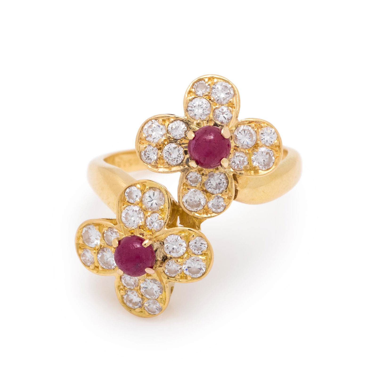 VAN CLEEF & ARPELS, RUBY AND DIAMOND 'TREFLE' RING: VAN CLEEF & ARPELS, RUBY AND DIAMOND 'TREFLE' RING Containing two round cabochon cut rubies measuring approximately 3.75-3.85 mm in diameter and 32 round brilliant cut diamonds weighing approximately