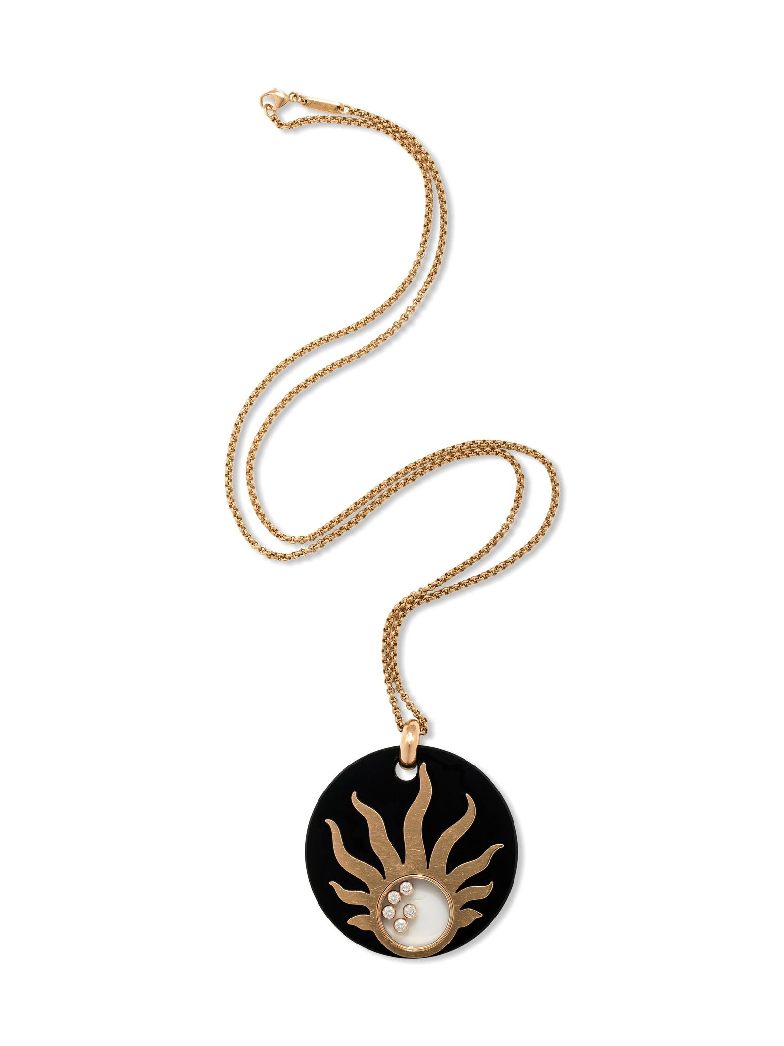 CHOPARD, ONYX AND DIAMOND 'HAPPY SUN' PENDANT/NECKLACE: CHOPARD, ONYX AND DIAMOND 'HAPPY SUN' PENDANT/NECKLACE Consisting of a round onyx disc pendant surmounted with a yellow gold sun containing five floating round brilliant cut diamonds weighing approxim
