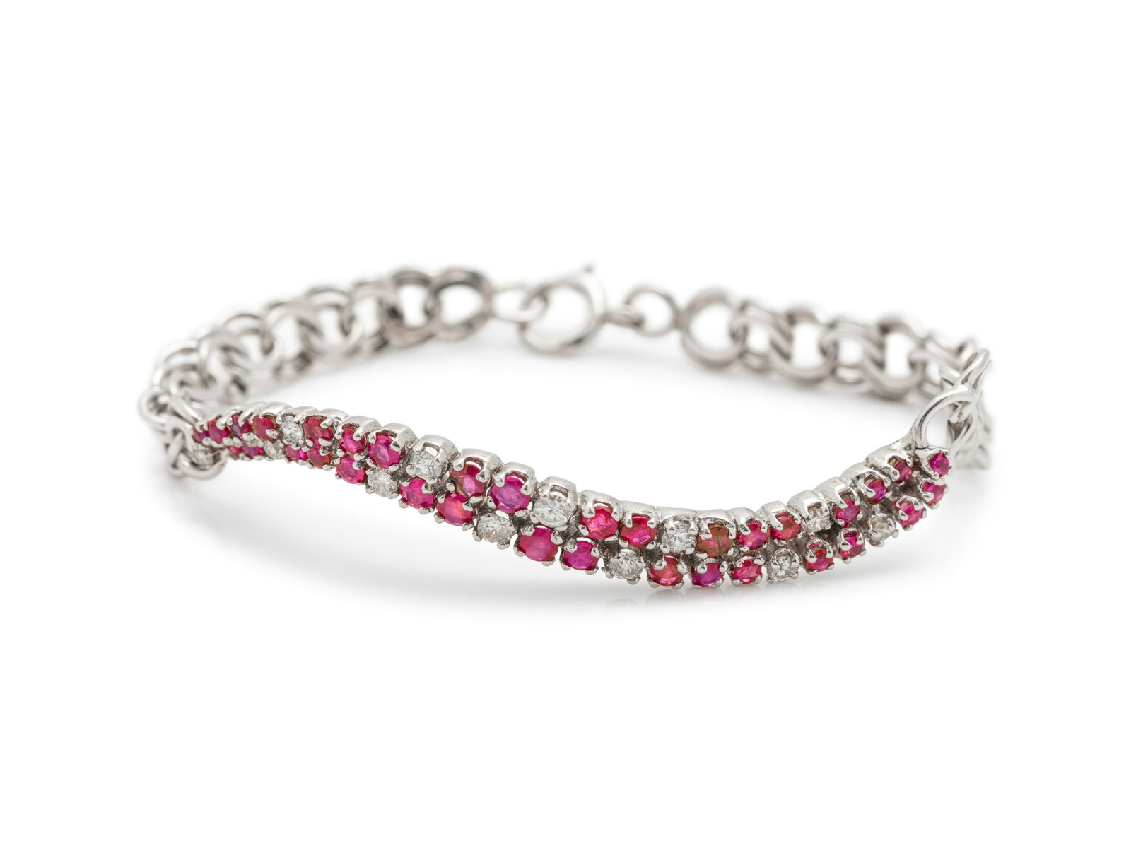 WHITE GOLD, RUBY AND DIAMOND BRACELET: WHITE GOLD, RUBY AND DIAMOND BRACELET Consisting of a fancy link bracelet with central section containing numerous round mixed cut rubies measuring approximately 1.40-2.70 mm in diameter and 12 round 