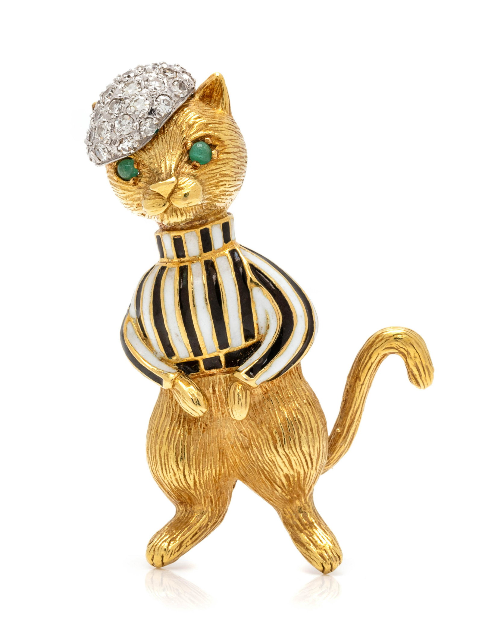 YELLOW GOLD, DIAMOND AND ENAMEL CAT BROOCH: YELLOW GOLD, DIAMOND AND ENAMEL CAT BROOCH Consisting of a textured yellow gold cat with white gold hat containing 28 single cut diamonds, with white and black enamel sweater and two round cabochon cu