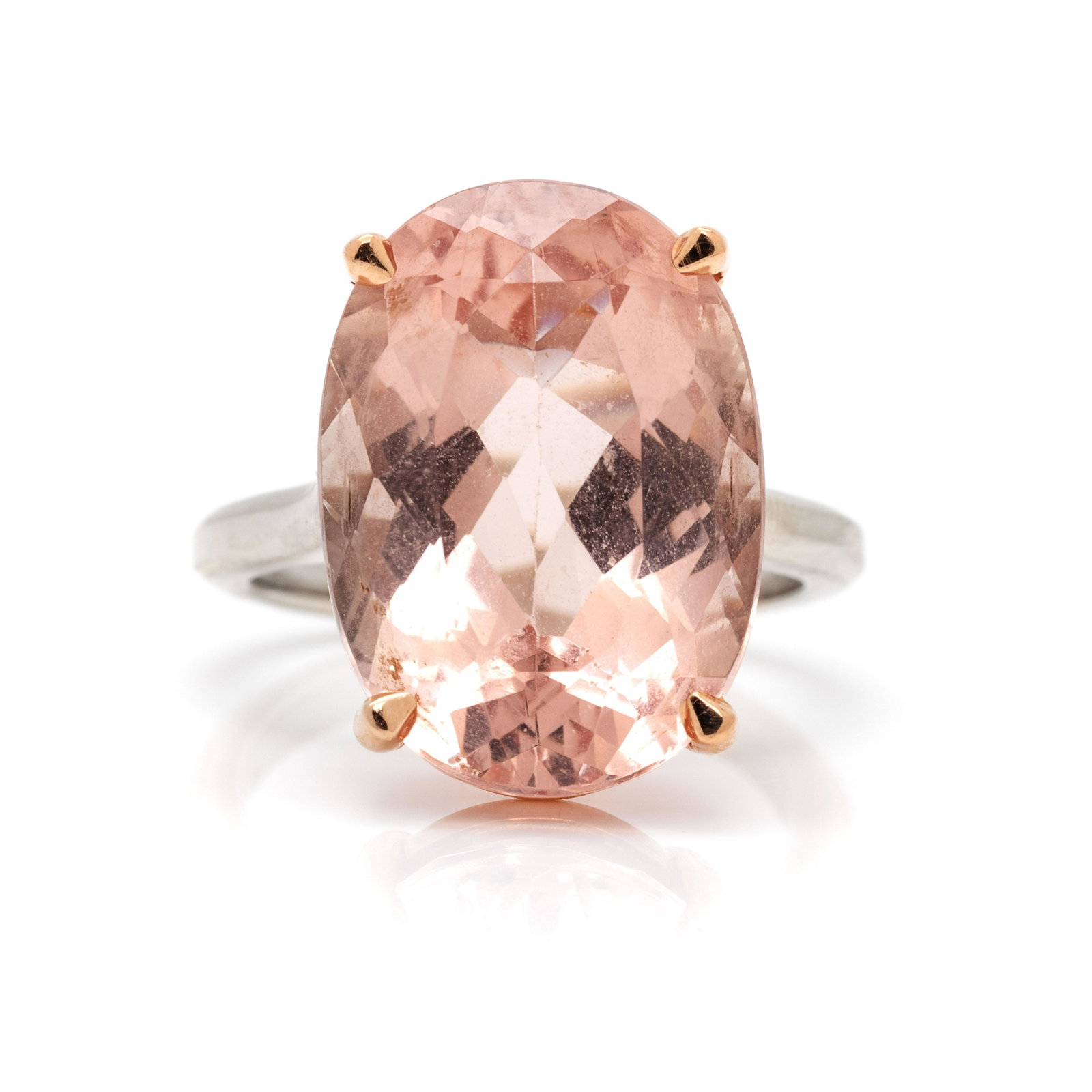 MORGANITE RING: MORGANITE RING Containing one oval mixed cut morganite measuring approximately 17.50 x 12.50 x 8.35 mm. Mounted in white and rose gold. 4.50 dwt.
