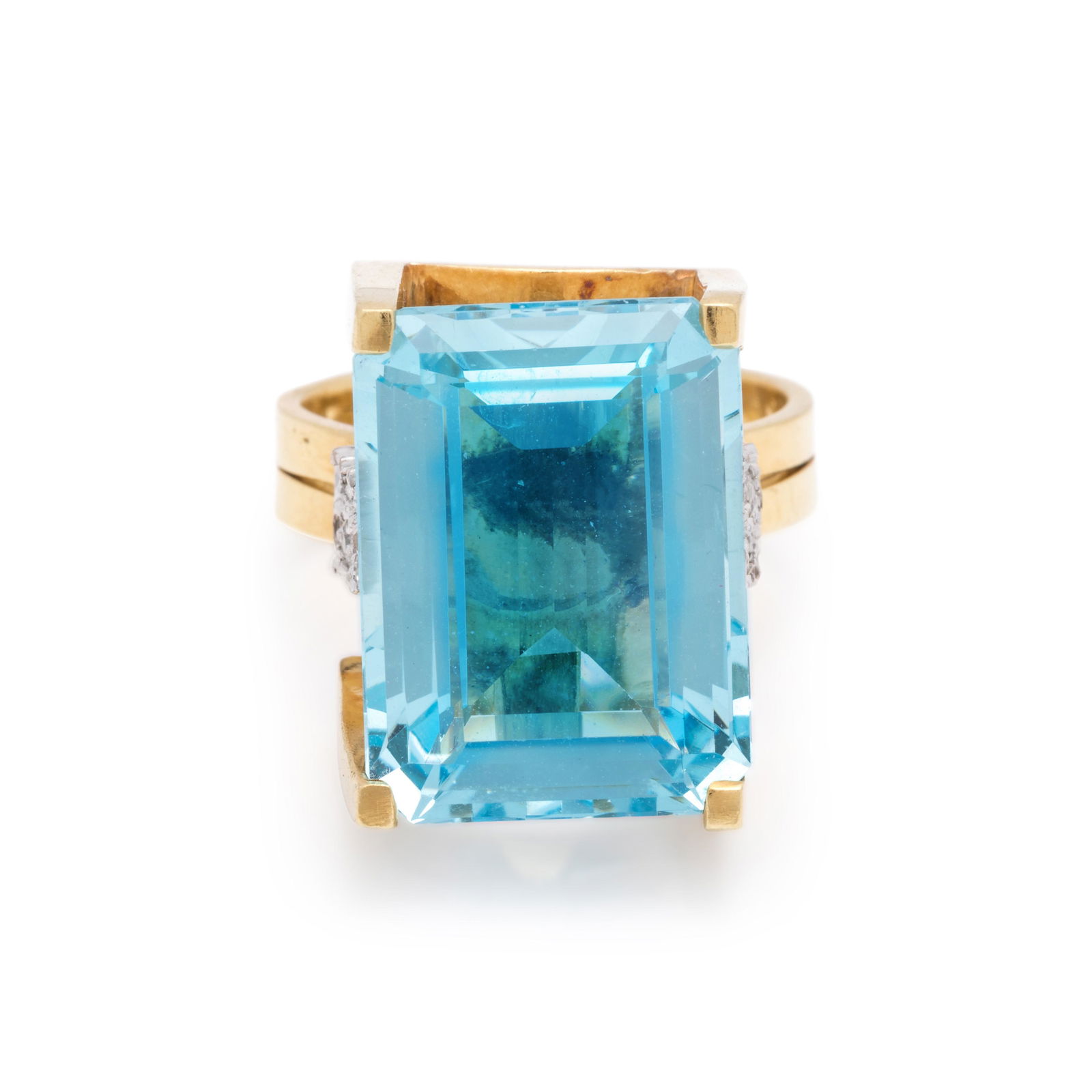 AQUAMARINE AND DIAMOND RING: AQUAMARINE AND DIAMOND RING Containing one emerald cut aquamarine measuring approximately 18.80 x 13.90 x 7.50 mm and 16 single cut diamonds. Mounted in yellow gold with white gold detail. Stamp: 8KH