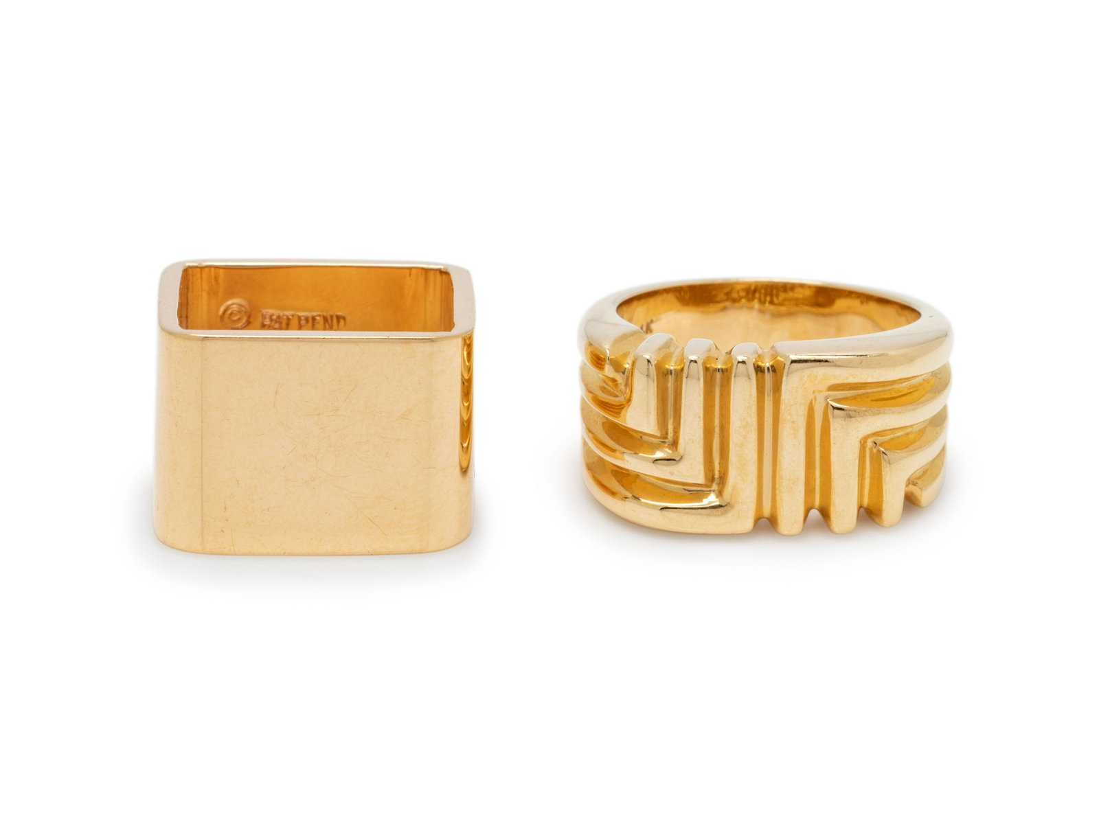 COLLECTION OF YELLOW GOLD RINGS: COLLECTION OF YELLOW GOLD RINGS Consisting of a linear design ring, together with a polished square shape cigar band ring. Stamp: 14K (maker's mark). Stamp: PAT PEND 14K PLUMB (maker's mark). 14.90 dw