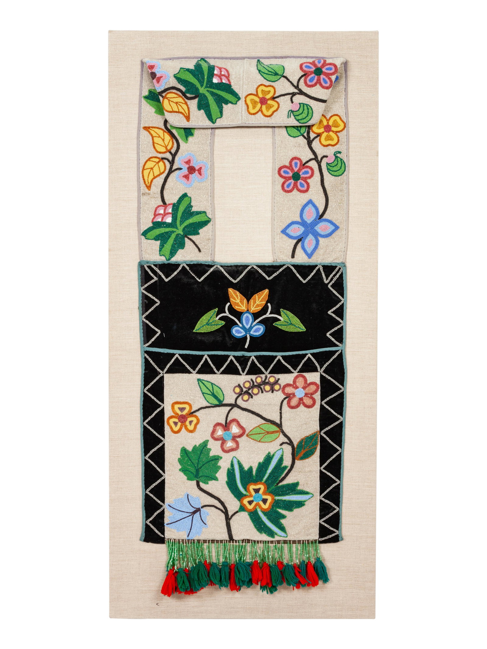 Anishinaabe Beaded Bandolier Bags, Matched Pair each: Anishinaabe Beaded Bandolier Bags, Matched Pair CA 1900 lot of 2, with complementing floral design; mounted on linen backing boards each height 41 x width 15 1/4 inches Property from the Dewar Family 