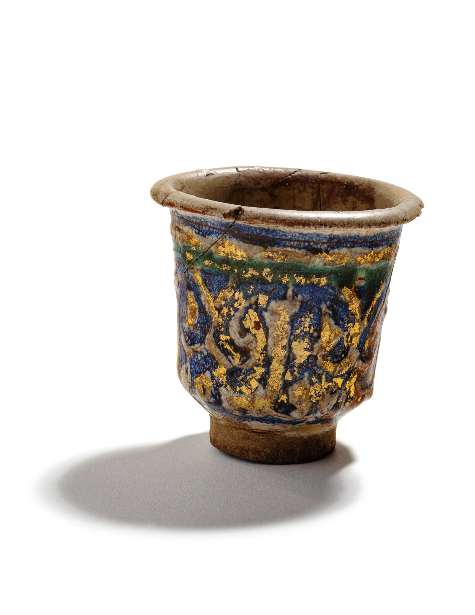 An Islamic Blue, Green and Iridescent Gold Glazed: An Islamic Blue, Green and Iridescent Gold Glazed Pottery Cup Circa 12th Century Height 2 7/8 inches.