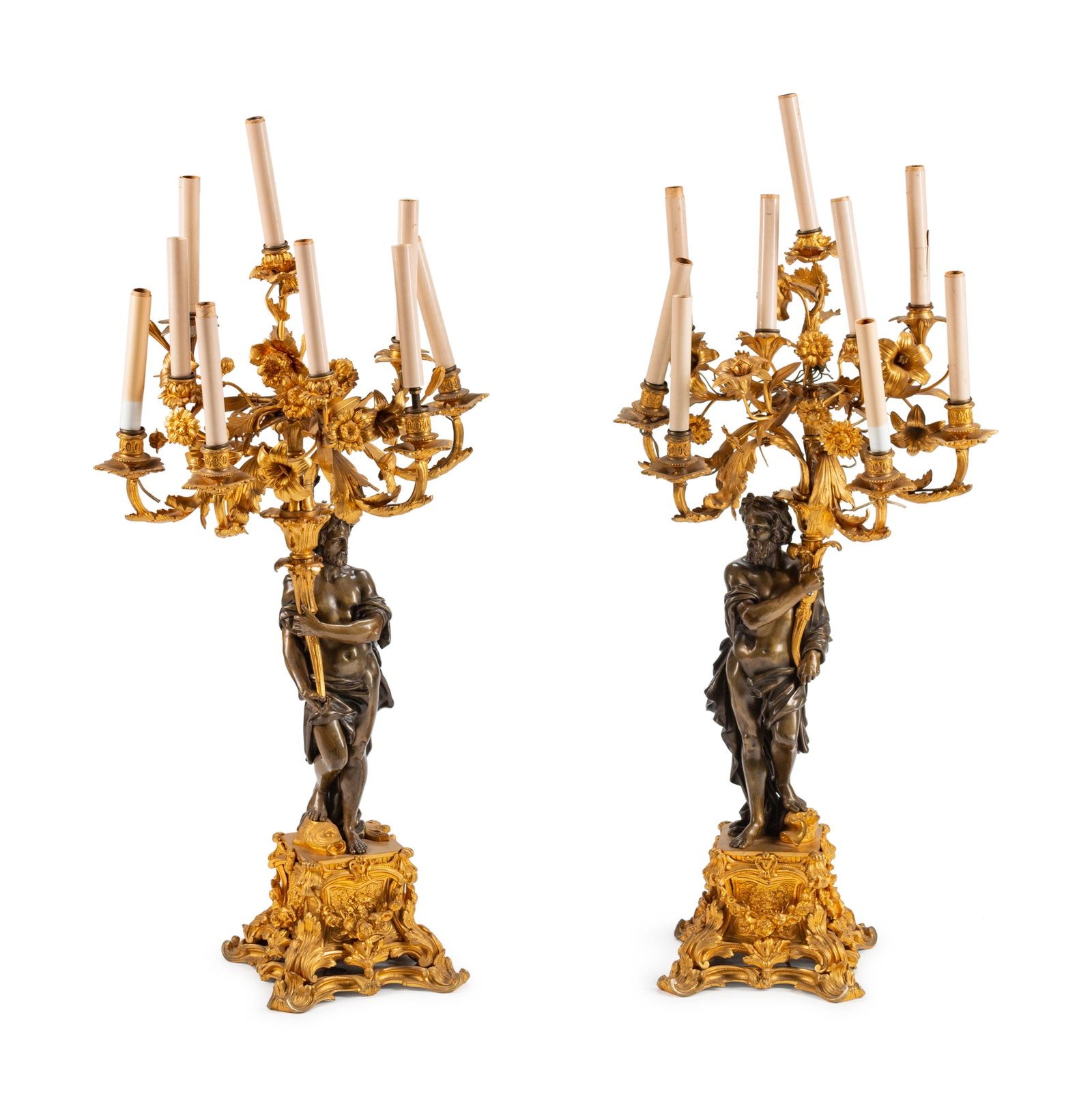 A Pair of Parcel-Gilt and Patinated Bronze Figural: A Pair of Parcel-Gilt and Patinated Bronze Figural Eight-Light Candelabra 19TH CENTURY Height 39 x width 17 x depth 16 inches.