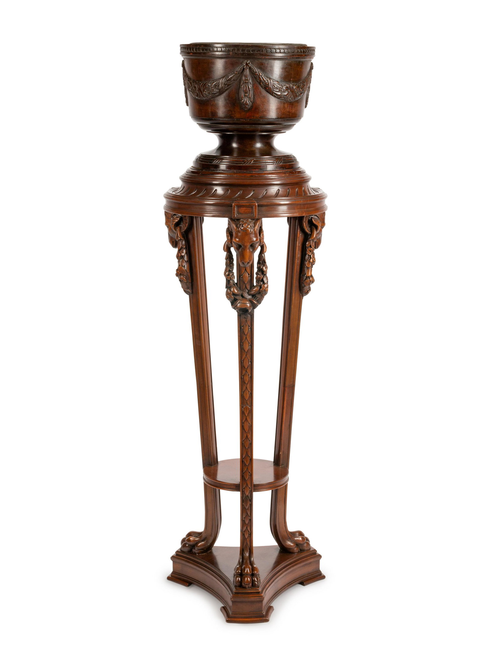A George III Style Carved Mahogany Jardiniere on: A George III Style Carved Mahogany Jardiniere on Pedestal Height 57 1/2 x diameter 17 inches.