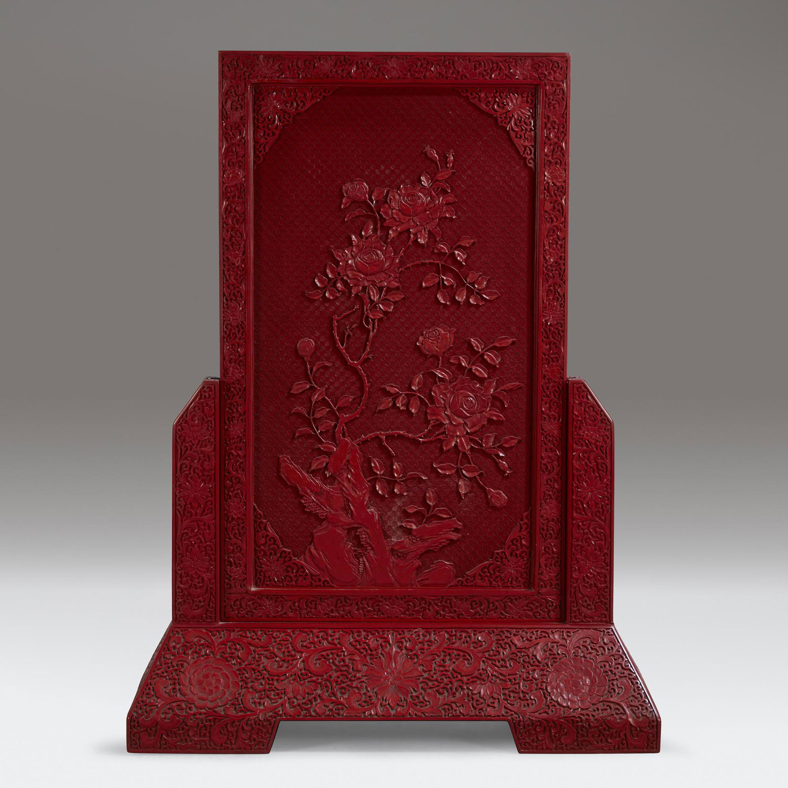 A large well-carved Chinese cinnabar lacquer screen, (1 of 3)