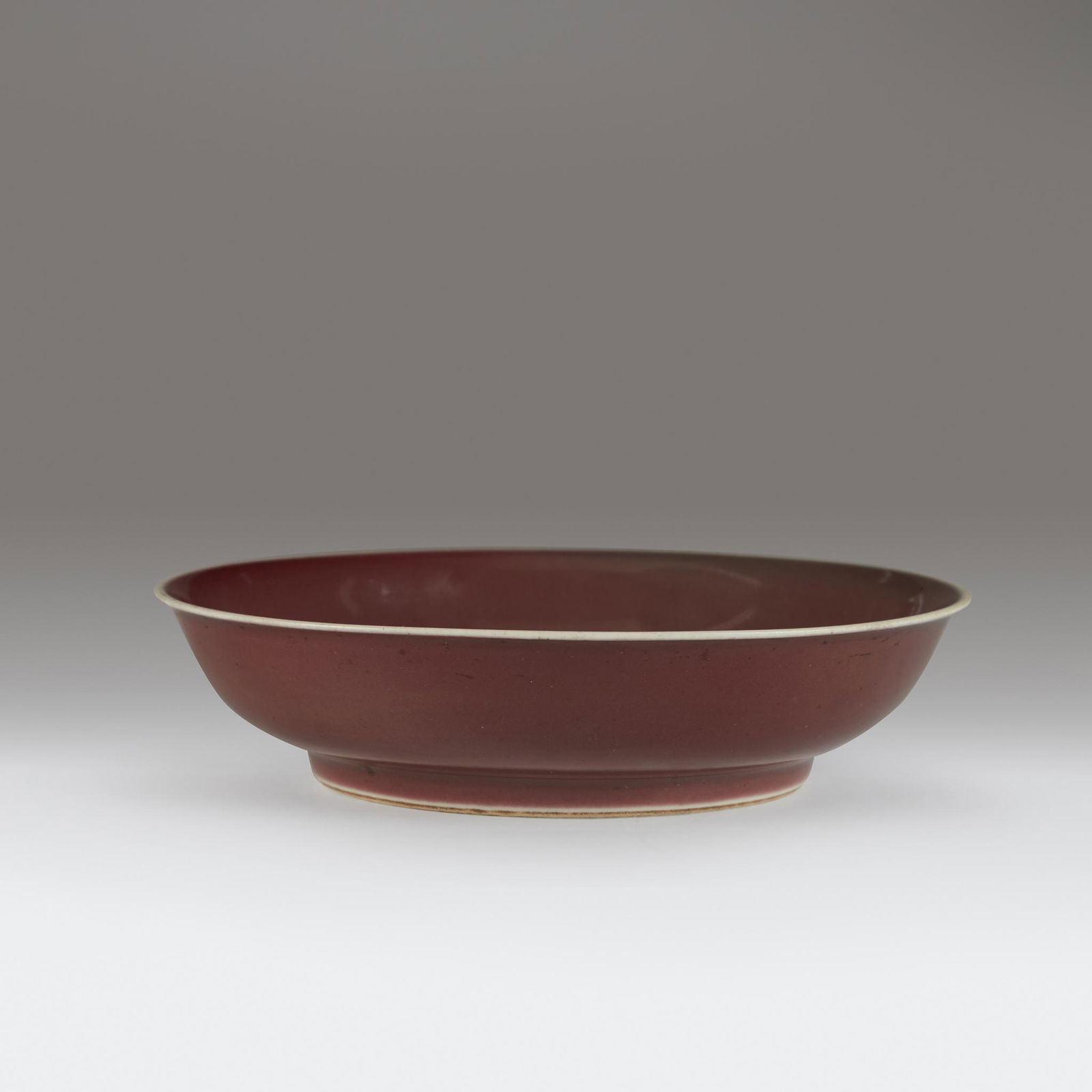A Chinese copper red-glazed porcelain dish, Qianlong (1 of 3)