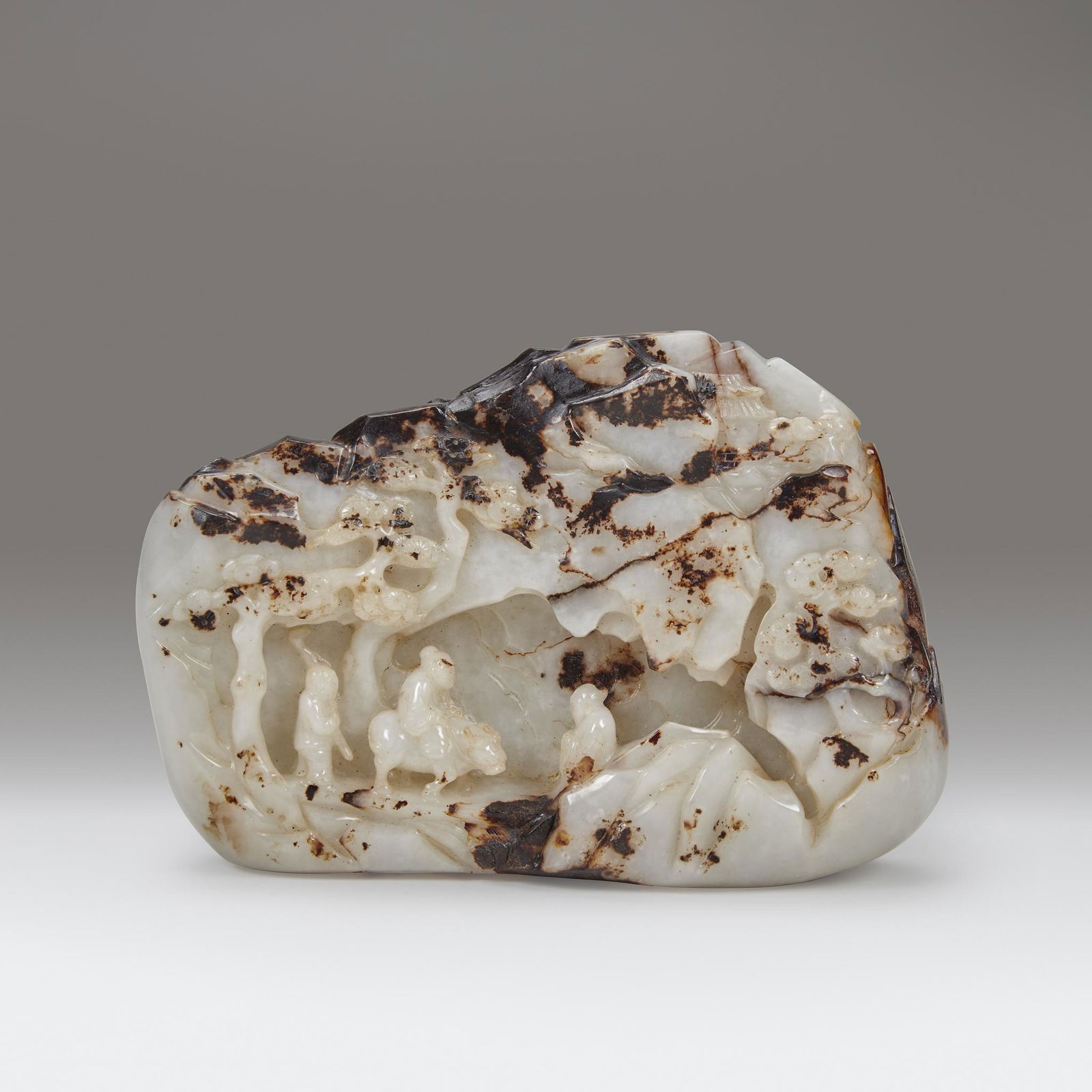 A Chinese carved white and dark brown jade "Mountain" (1 of 2)