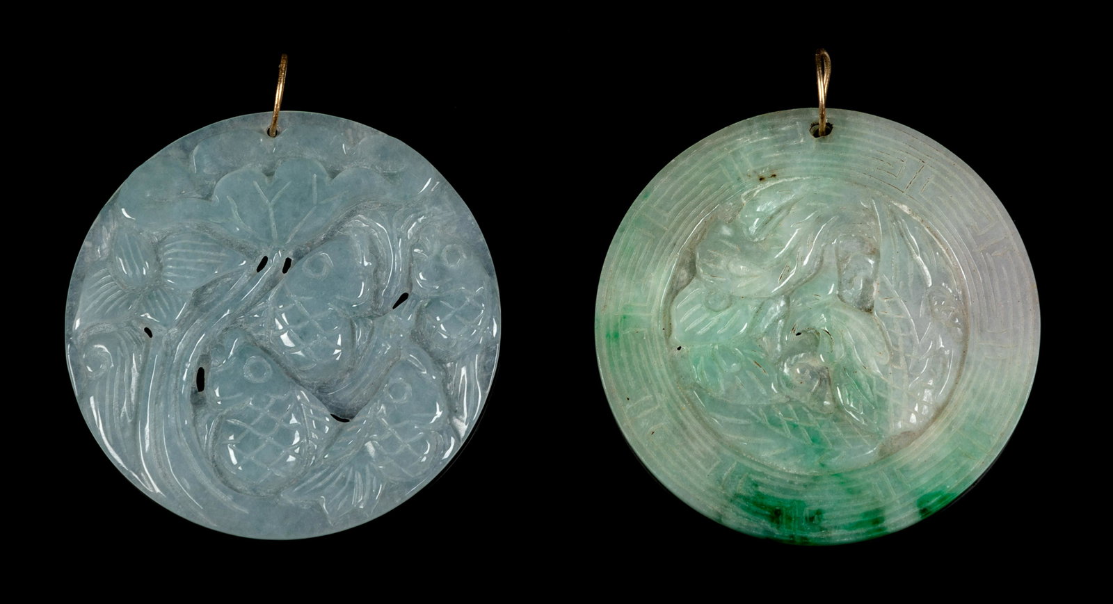 Two Chinese Apple Green and Celadon Jadeite Circular: Two Chinese Apple Green and Celadon Jadeite Circular Pendants 20TH CENTURY the first carved to show a dragon and a phoenix, the second carp underneath a lotus branch. Larger: diam 3 in., 8 cm. Propert