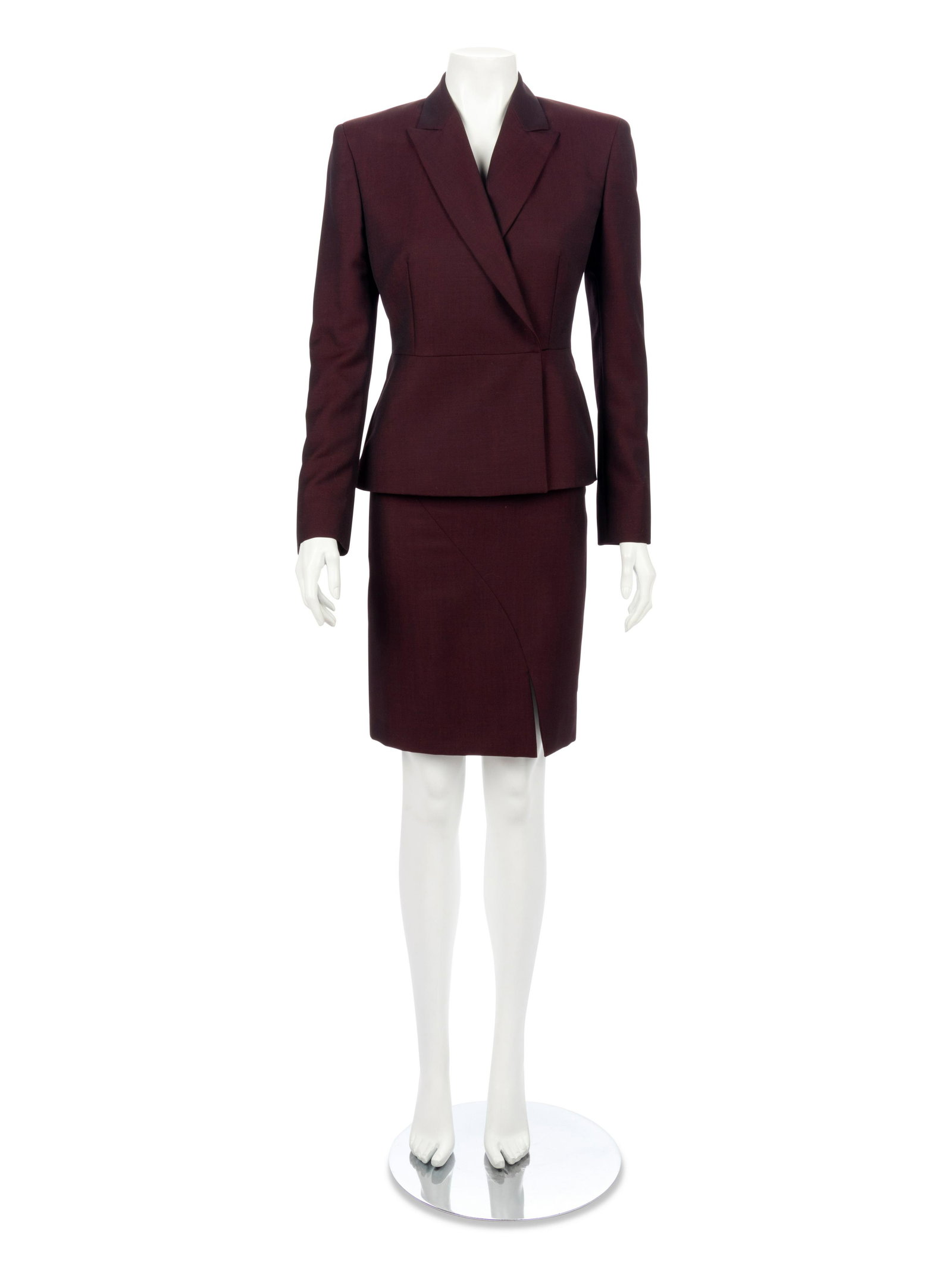 Gucci Skirt Suit, 1990-2000s: Gucci Skirt Suit, 1990-2000s Burgundy wool blend skirt suit with fish-eye lapel and single button front closure jacket; paired with a matching straight fist skirt with front right side slit. Label