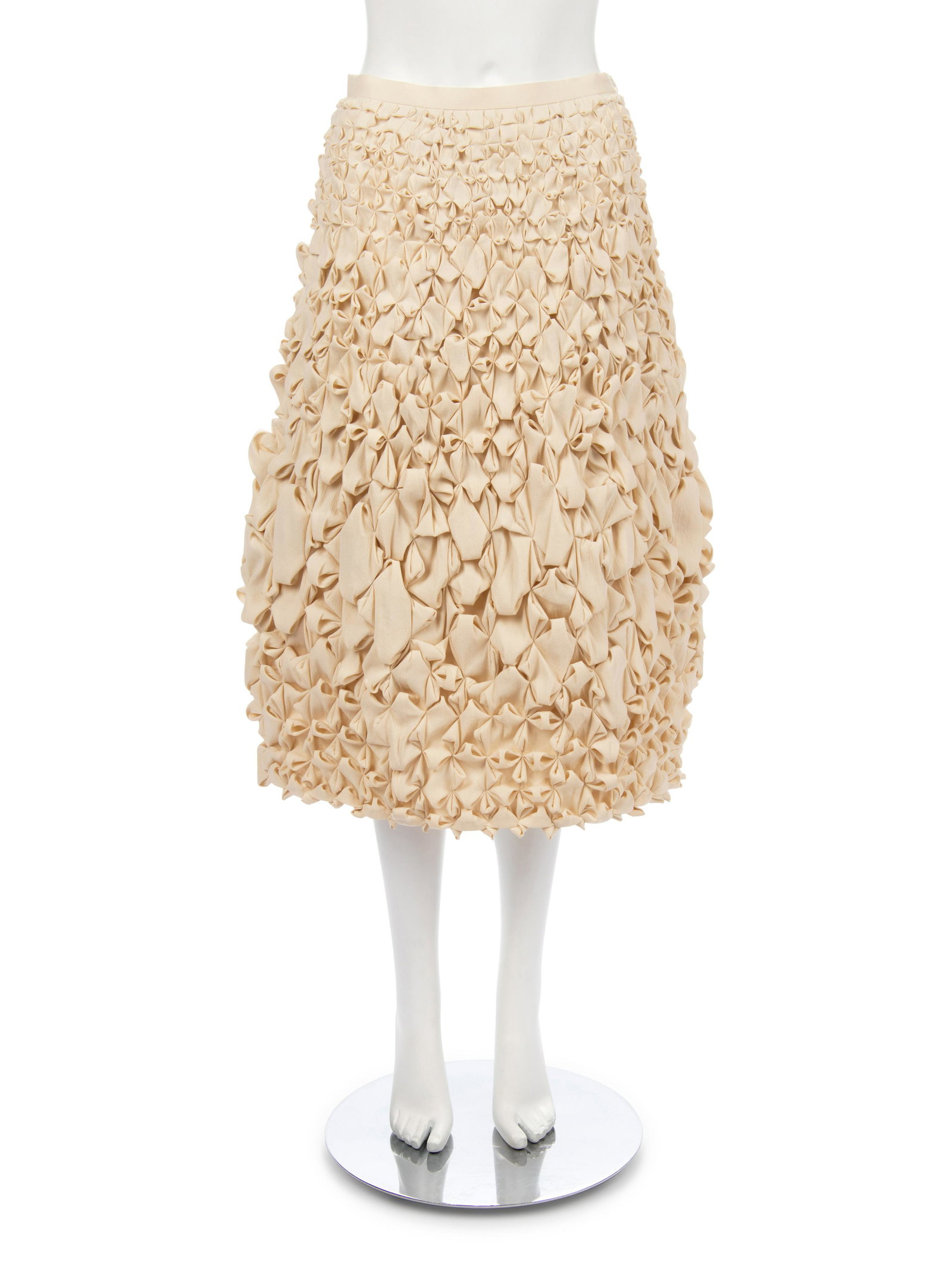 Issey Miyake Gathered Skirt, 2001: Issey Miyake Gathered Skirt, 2001 Cream polyester blend crepe flared skirt with folded and gathered over skirt. Label: Issey Miyake Size Label: 3 Approximate Measurements: Waist: 27.75" Hips: 35