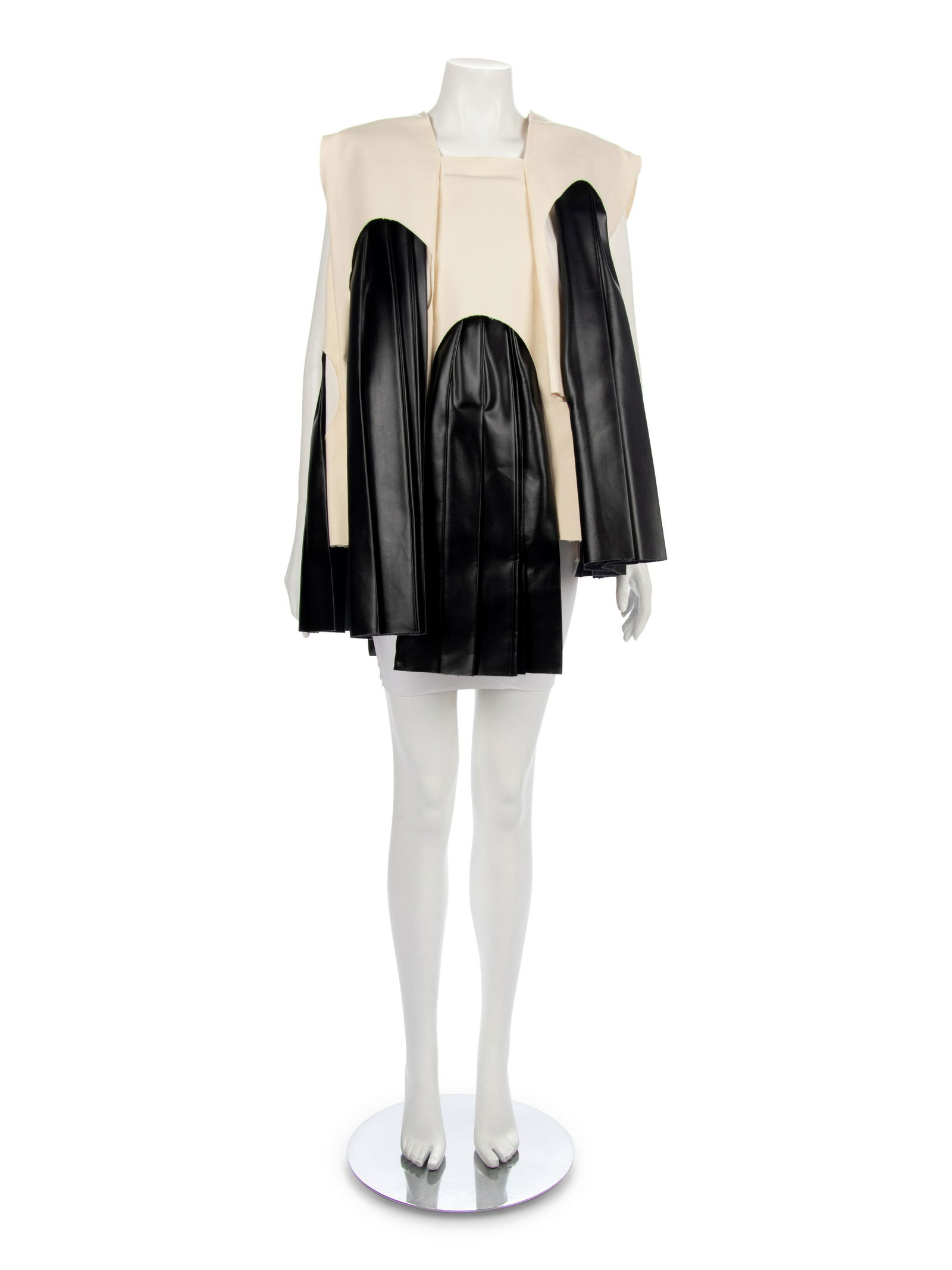 Comme des Garcons Black Faux Leather and Natural Muslin: Comme des Garcons Black Faux Leather and Natural Muslin Tunic, 1990-2000s Natural cotton canvas muslin tunic with pleated black synthetic leather Label: Comme des Garcons Approximate Measurements: Sho