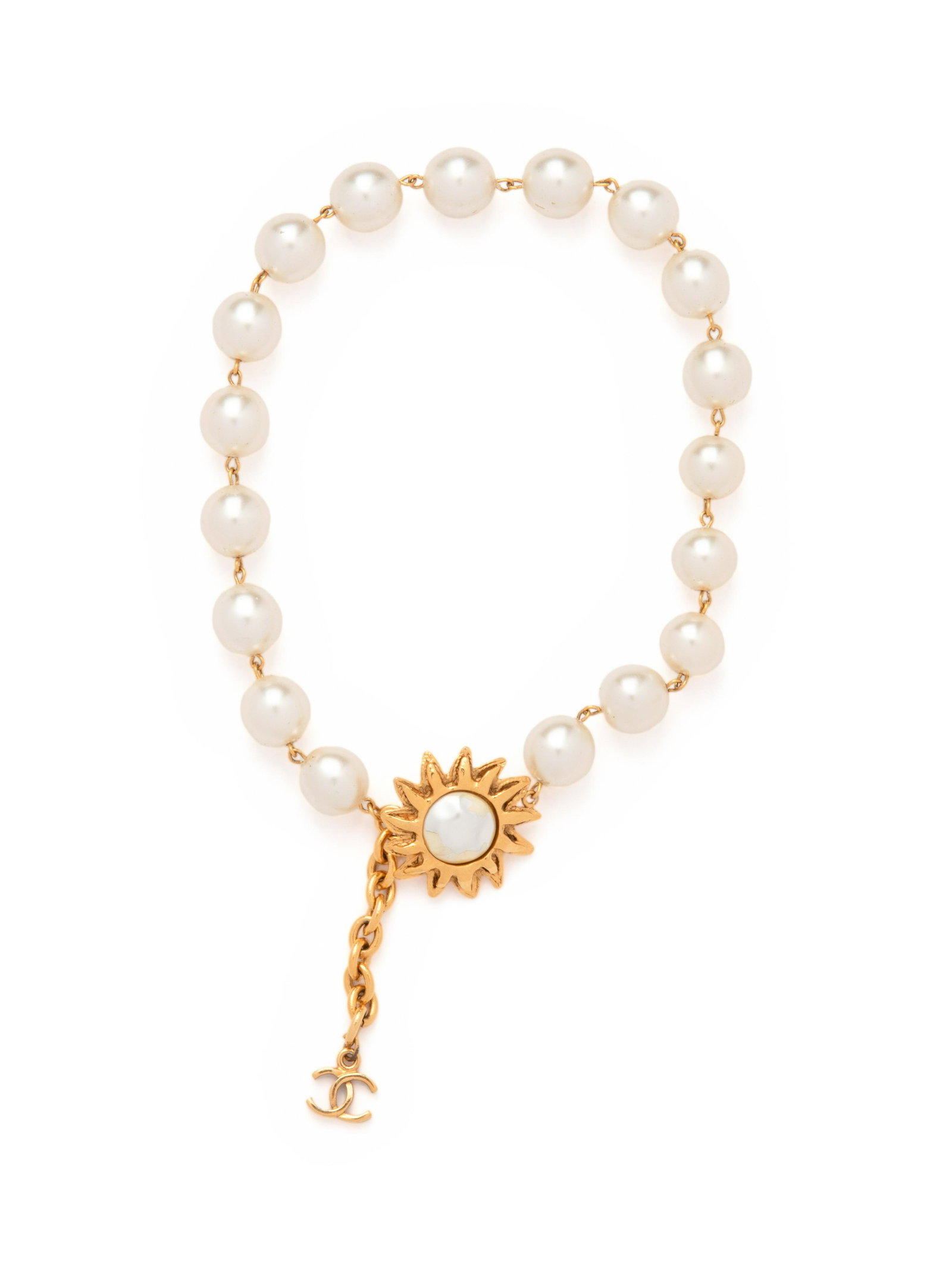 Chanel Large Faux Pearl Necklace with Gold Flower,: Chanel Large Faux Pearl Necklace with Gold Flower, Early 1980s Large single strand faux pearl necklace with a large flower and gold double C pendant at closure. Label (stamped): Chanel, double C
