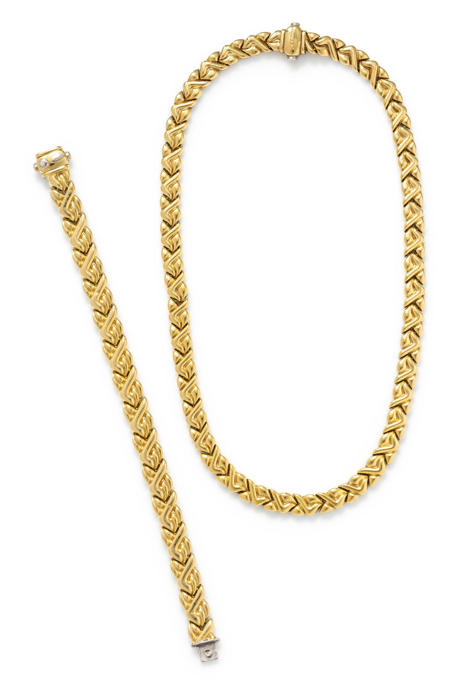 CHIMENTO, REVERSIBLE BICOLOR GOLD SET: CHIMENTO, REVERSIBLE BICOLOR GOLD SET Consisting of a sculptural link necklace with one side yellow gold, the other white gold, together with a matching bracelet with clasp containing one round brilli