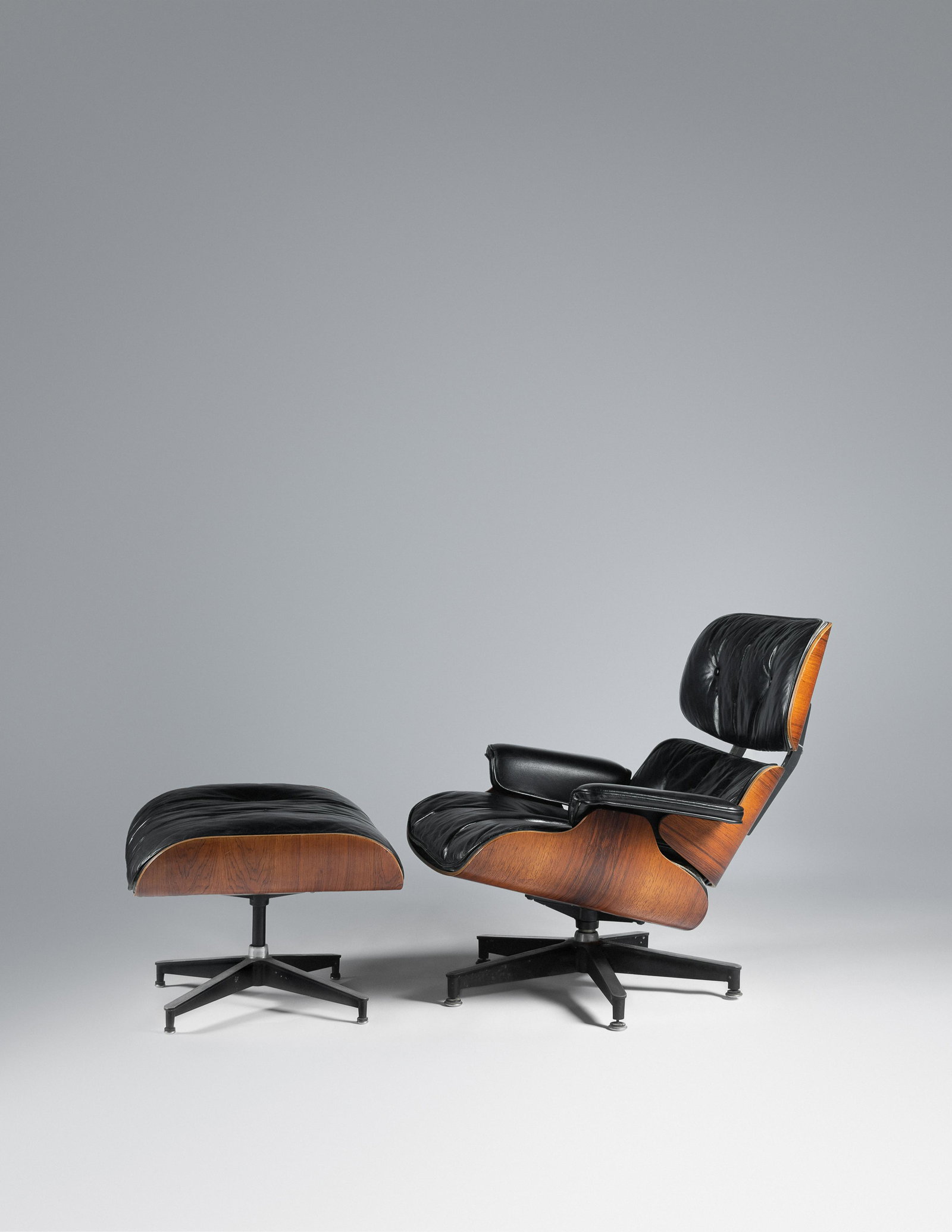Charles and Ray Eames (American, 1907-1978 | American,: Charles and Ray Eames (American, 1907-1978 | American, 1912-1988) Lounge Chair and Ottoman,model 670 and model 671, Herman Miller, USA rosewood plywood, leather, enameled aluminum, rubber manufacturer