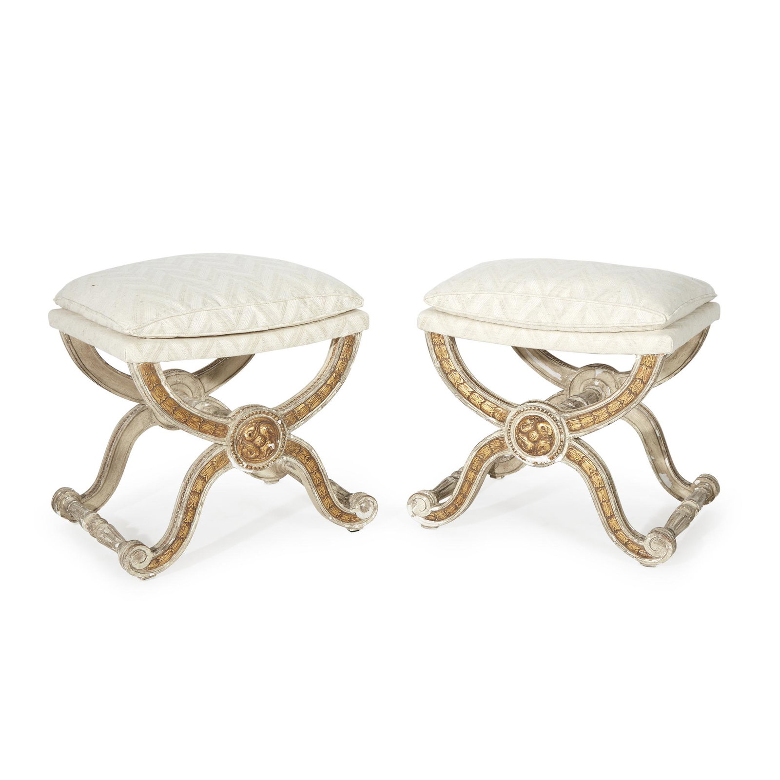 A pair of Louis XVI style cream-painted and parcel-gilt: A pair of Louis XVI style cream-painted and parcel-gilt tabourets19th/20th centuryH: 19 1/2, W: 21, D: 15 in.